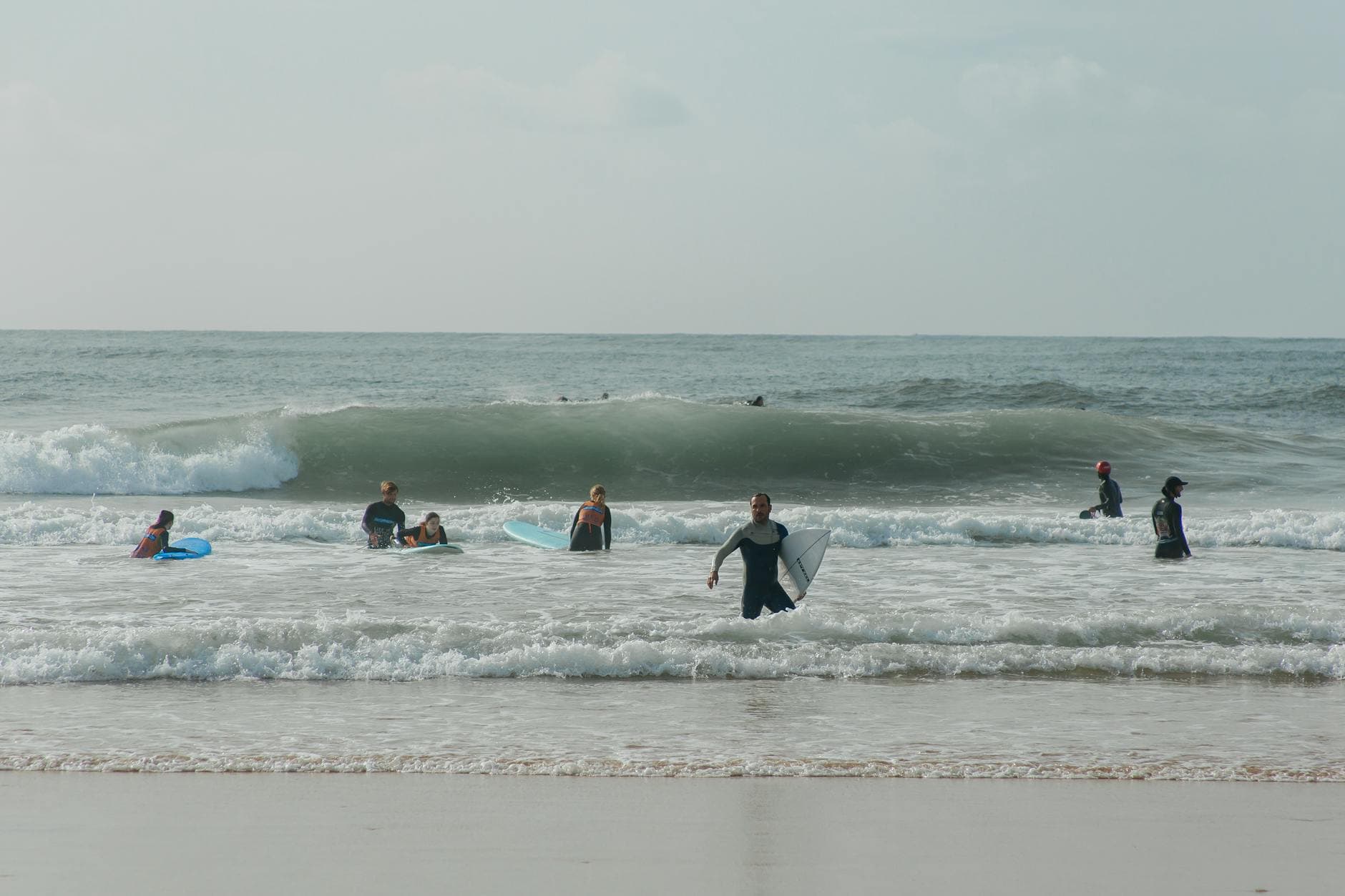 Group of surfers enjoying a day of surfing and fun at the beach with waves. - beginner exercises