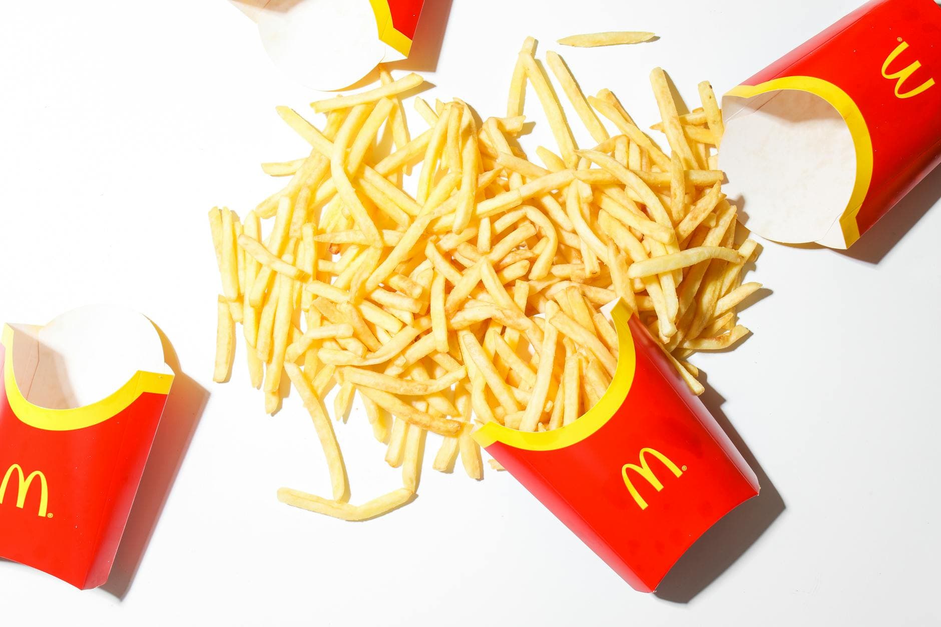 Delicious McDonald's French fries spilled on a bright white background. - healthy mcdonalds breakfast