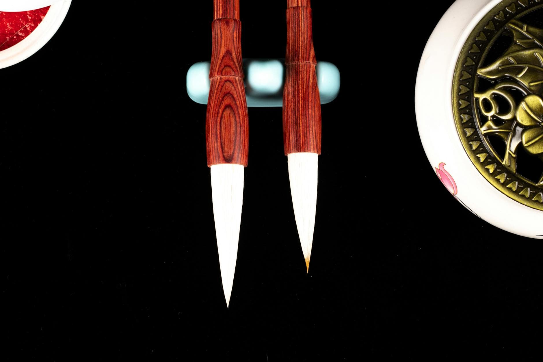 Top view of bright calligraphy brush pens with soft tips and bamboo shafts near decorative plant - hydration tips spring