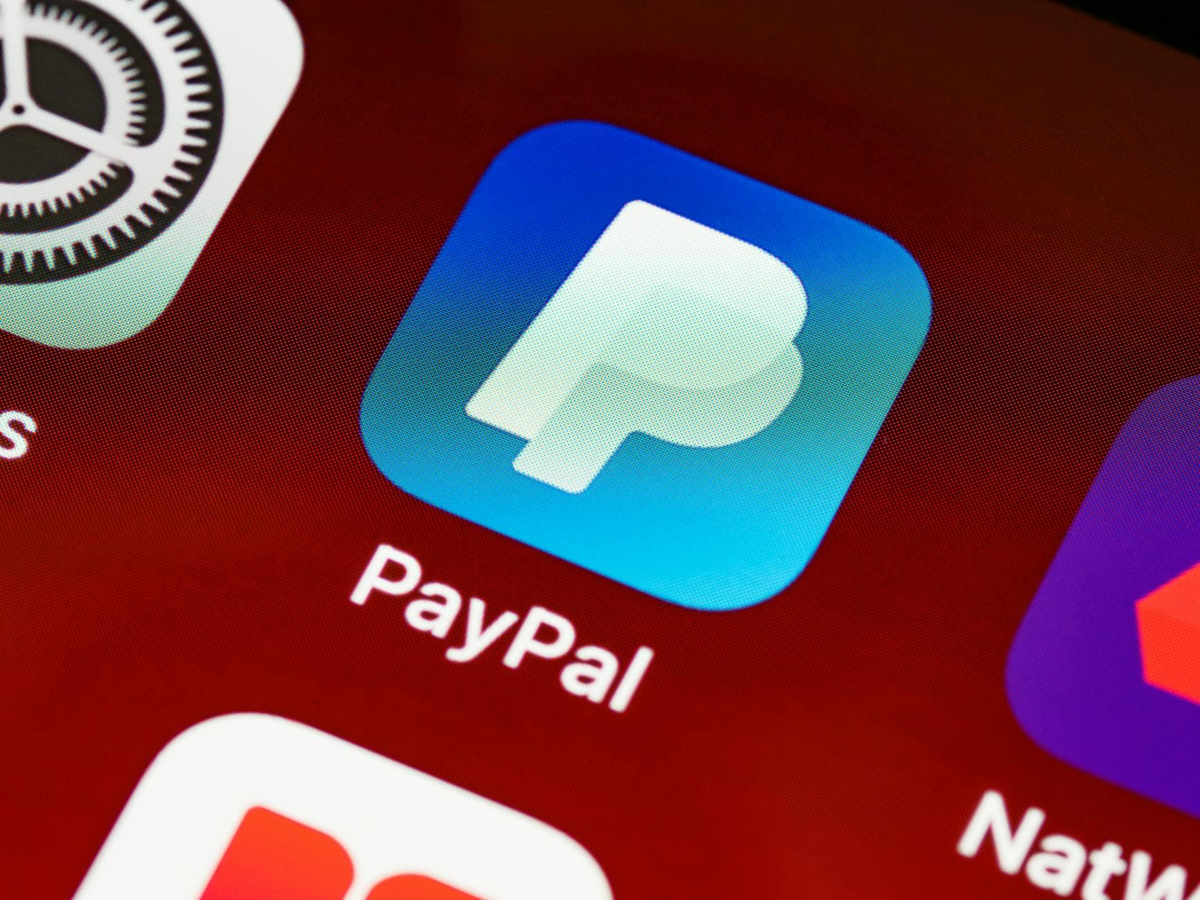 Detailed view of PayPal app icon on a smartphone screen highlighting mobile payment technology. - running apps for beginners