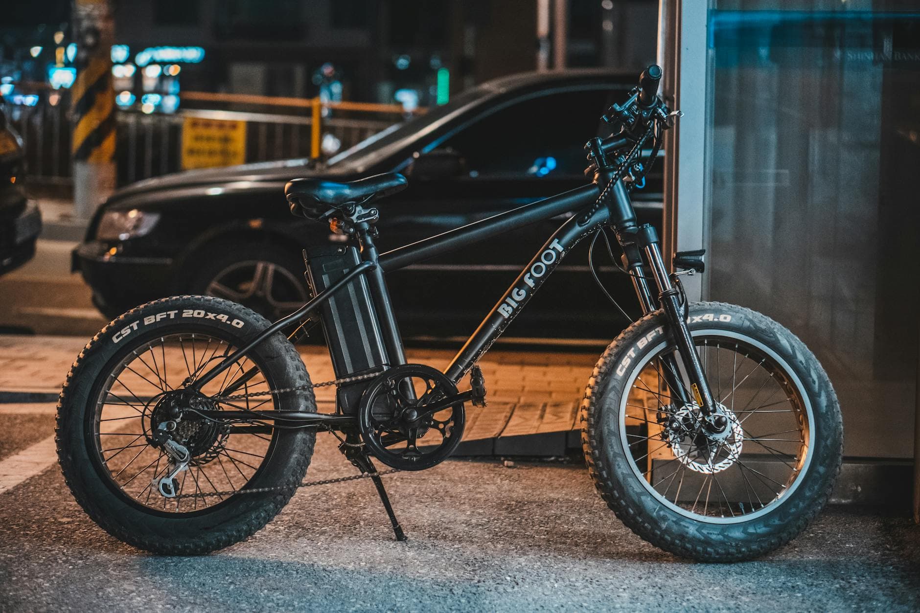 A modern e-bike parked by the sidewalk in an urban setting at night, showcasing technology. - spring fat burning
