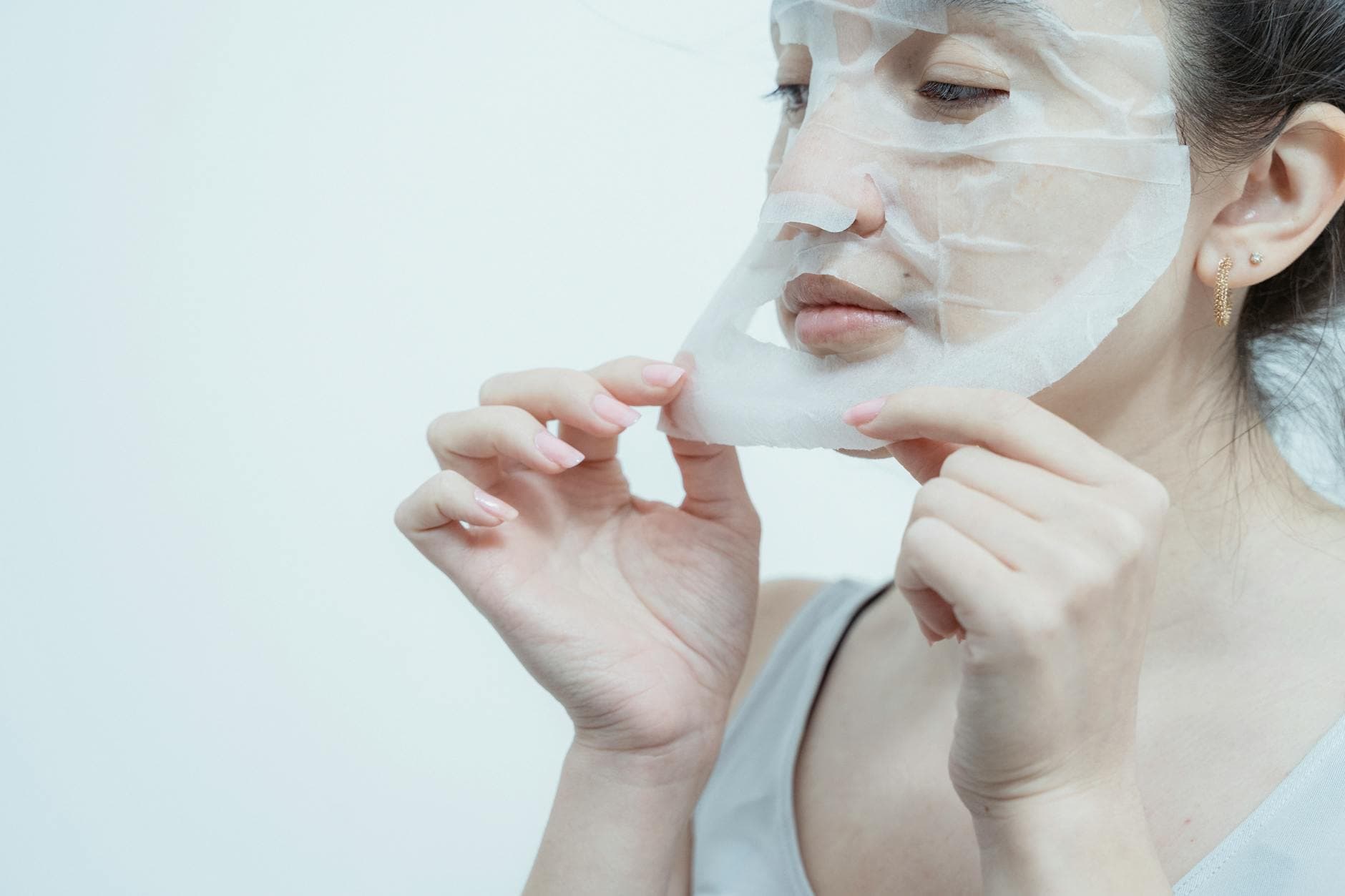 Close-up of a woman applying a hydrating face mask. Perfect for skincare and beauty content. - spring skin care
