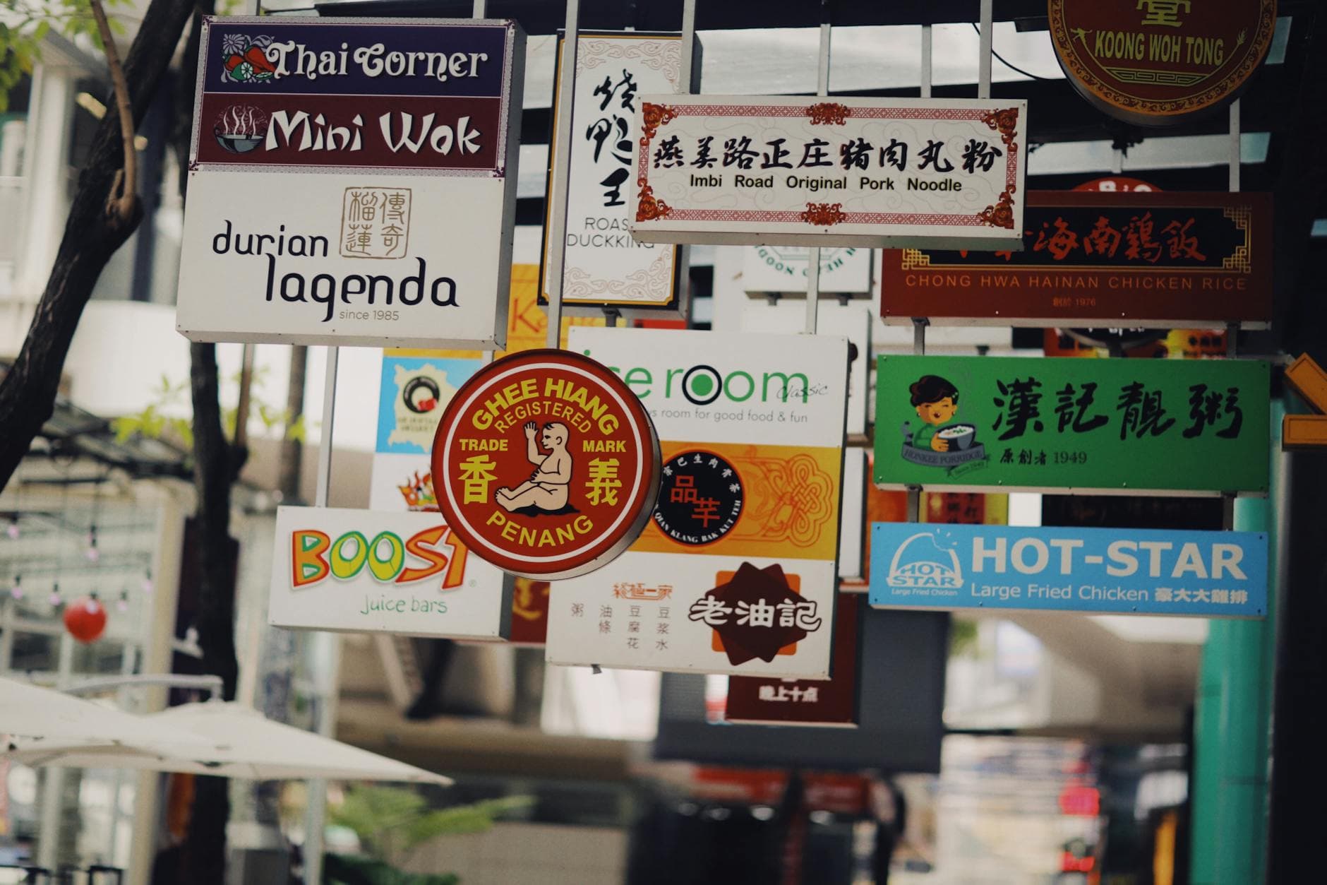 Colorful mix of multilingual signs in a busy Asian street, showcasing diverse cuisines and cultures. - sunlight mood boost