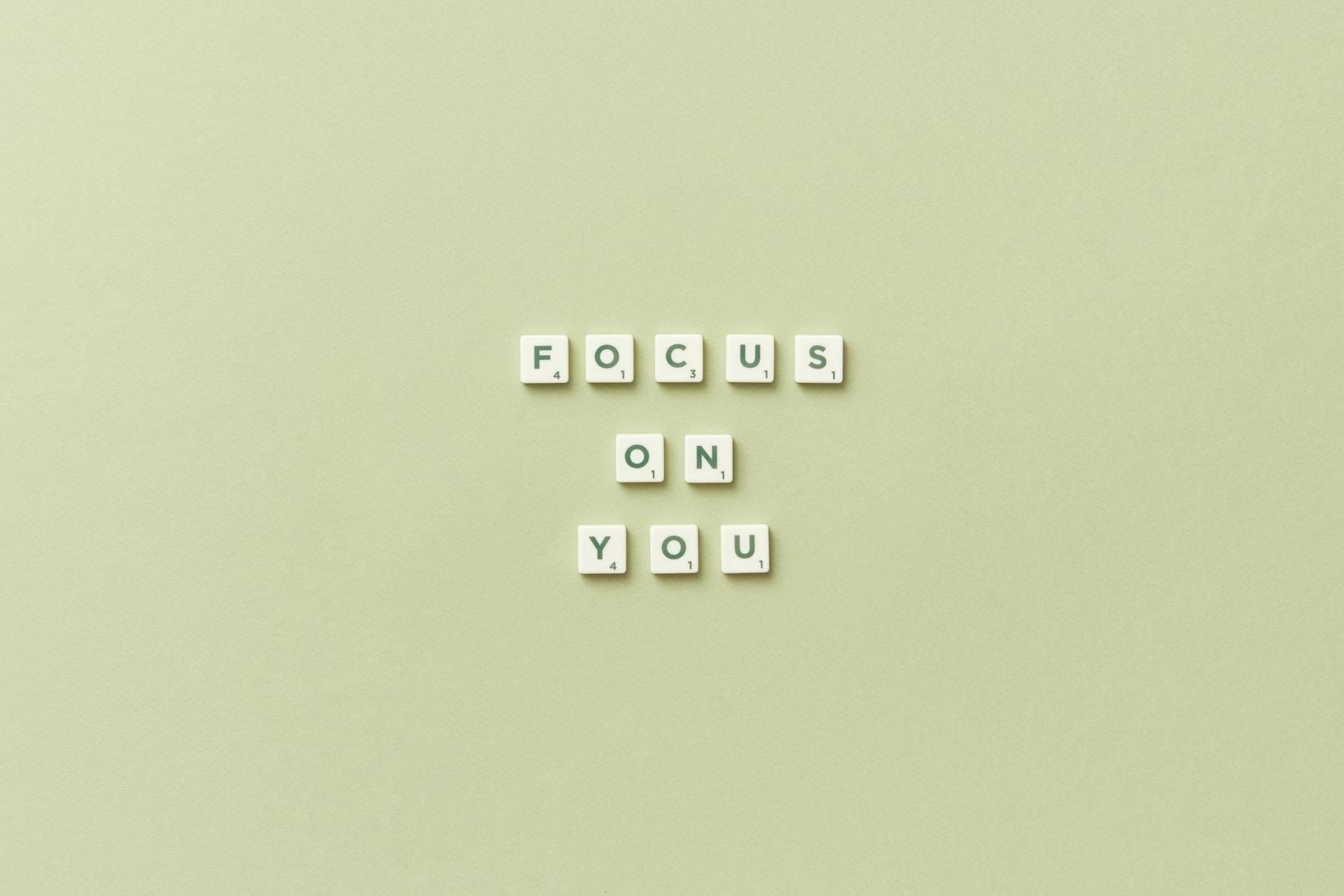 Scrabble tiles spell 'Focus on You' on a green background, promoting self-care. - mental clarity tips