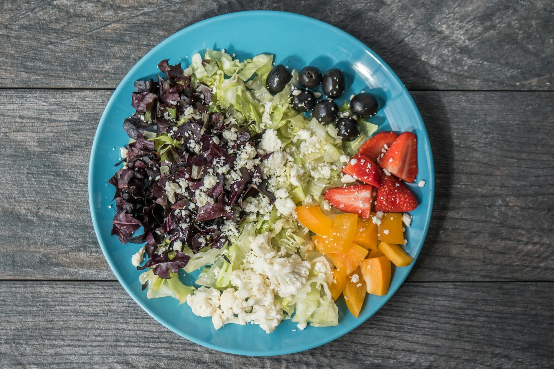 A vibrant and healthy salad featuring a mix of fresh vegetables, feta cheese, and olives, perfect for a nutritious meal. - spring inflammation diet