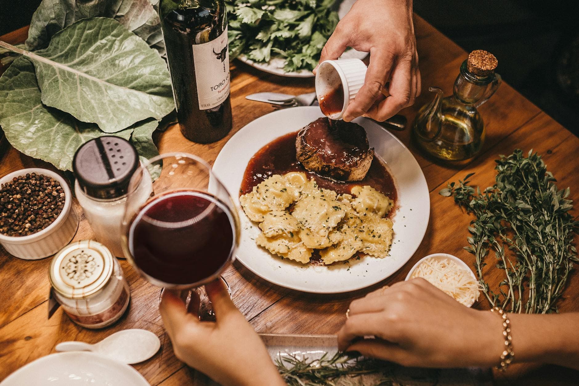 A delicious meal with wine, herbs, and richly seasoned meat prepared indoors. - easy dinner for two