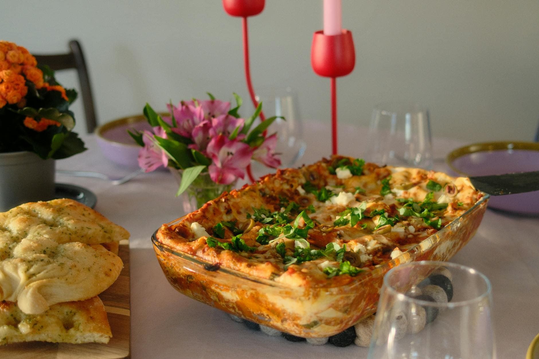 Cozy dinner table with homemade lasagna and floral decor, perfect for gatherings. - easy weeknight dinners