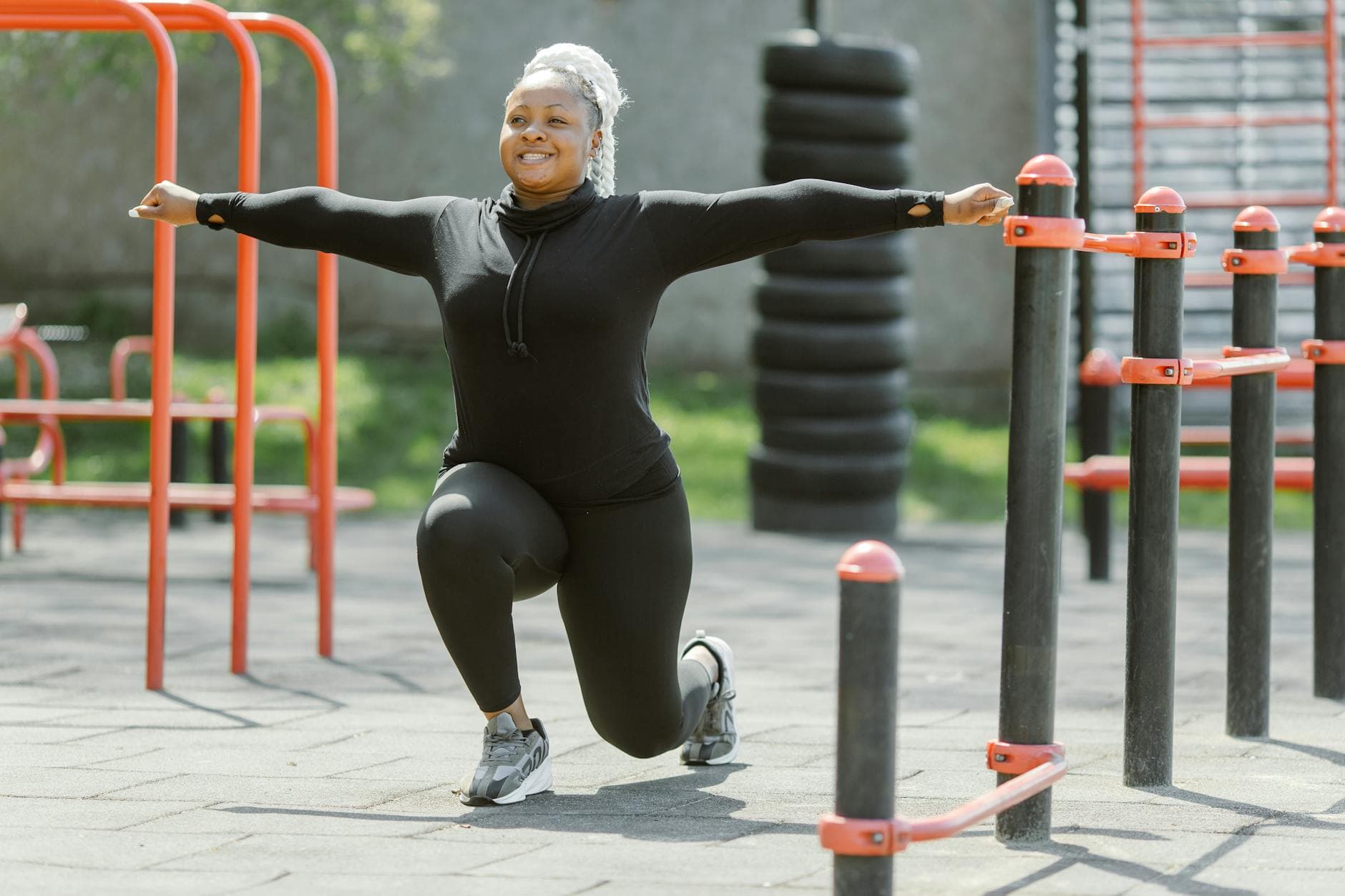 African American woman exercising in a park, promoting a healthy lifestyle. - outdoor hiit spring