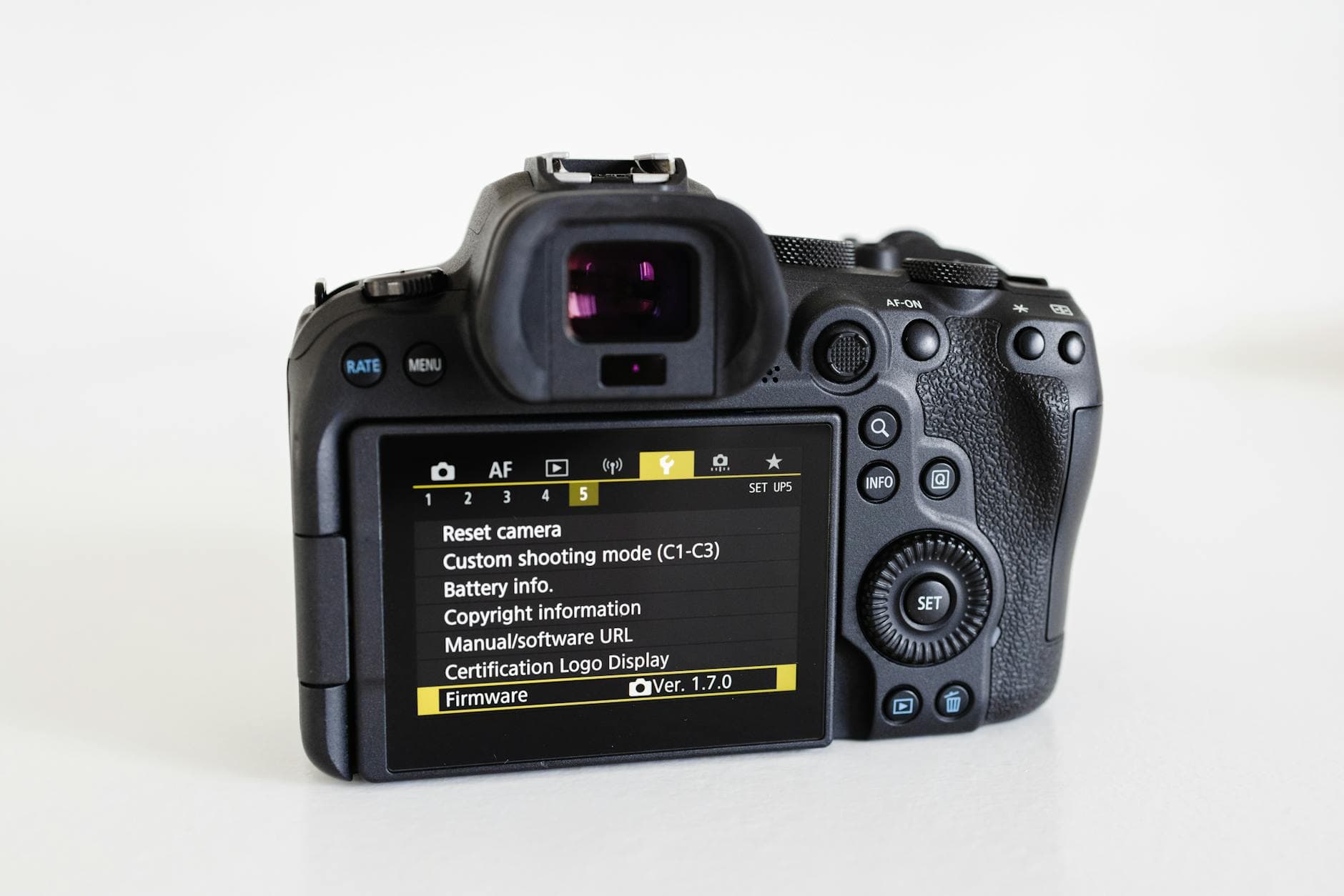 Close-up of a camera with a visible digital screen showcasing settings on a white background. - spring body reset