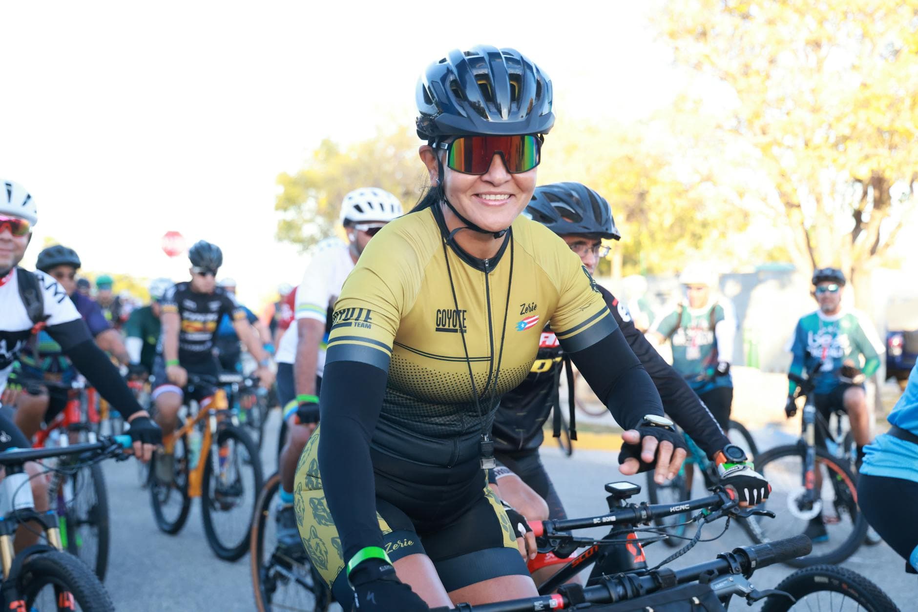 Cyclists gathered at an outdoor event, wearing helmets and gear, ready for a competition. - spring cycling fitness