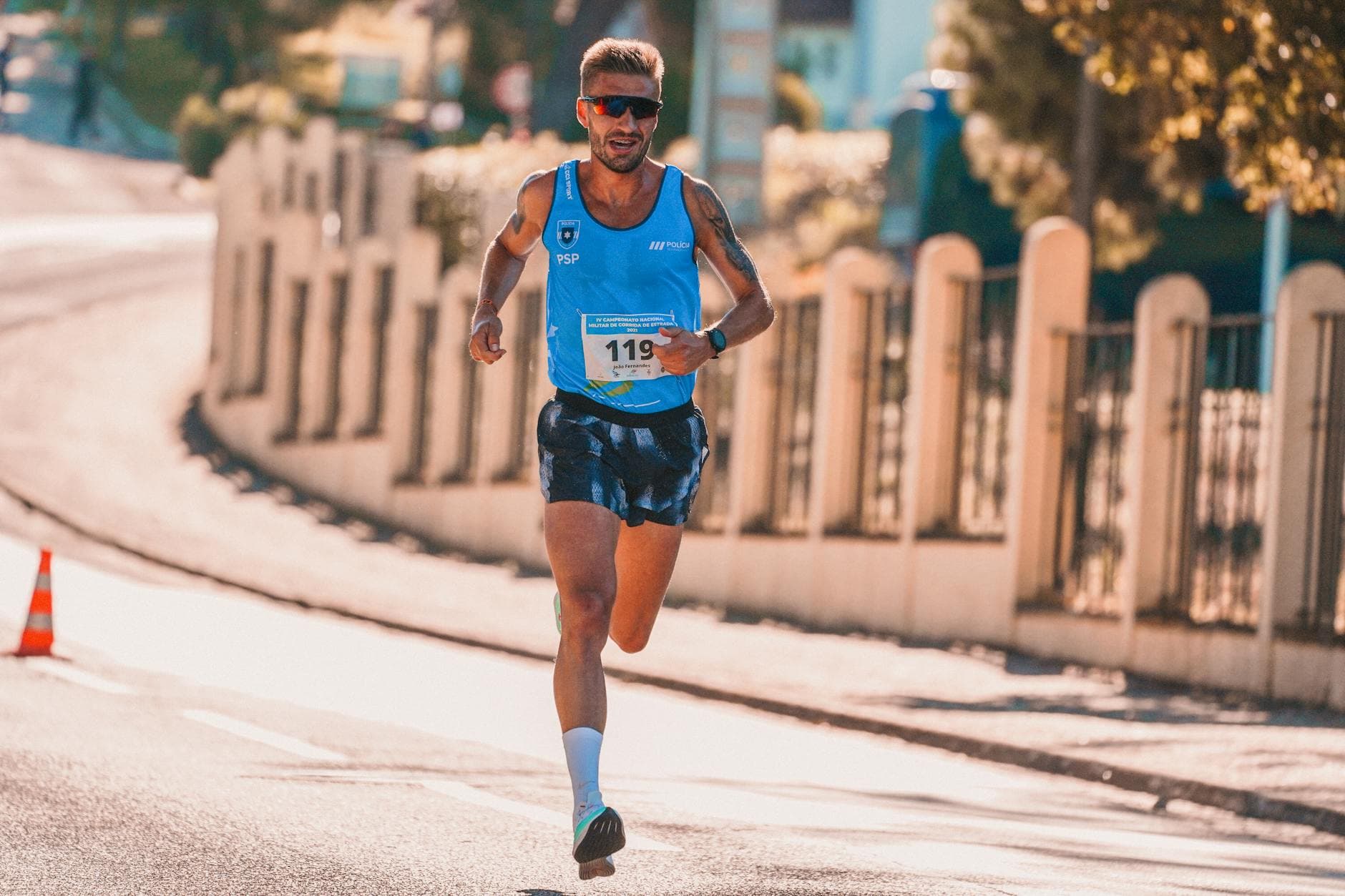 Male athlete running in an urban marathon under sunny conditions. - spring marathon training