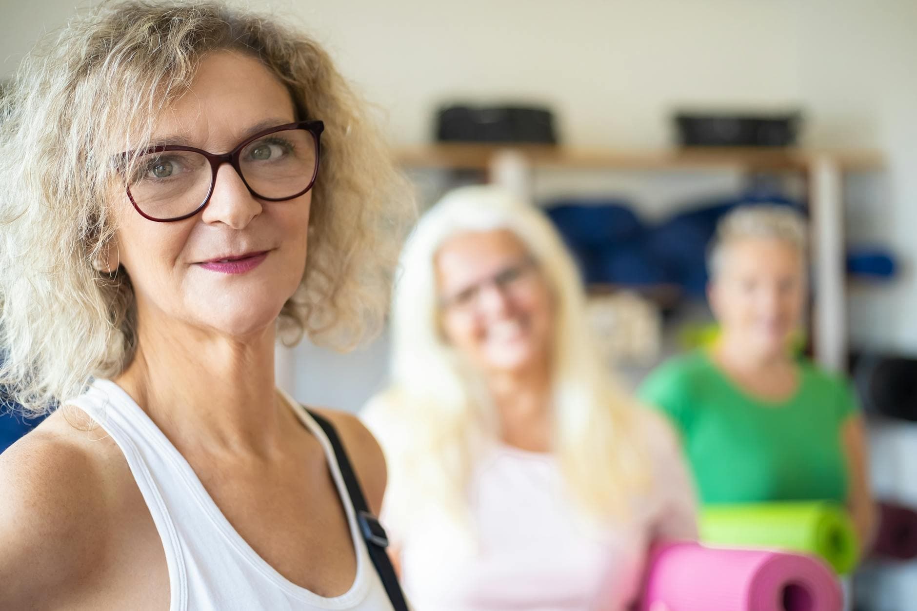Group of senior women enjoying a fitness class with yoga mats. Positive and active lifestyle. - healthy aging tips seniors