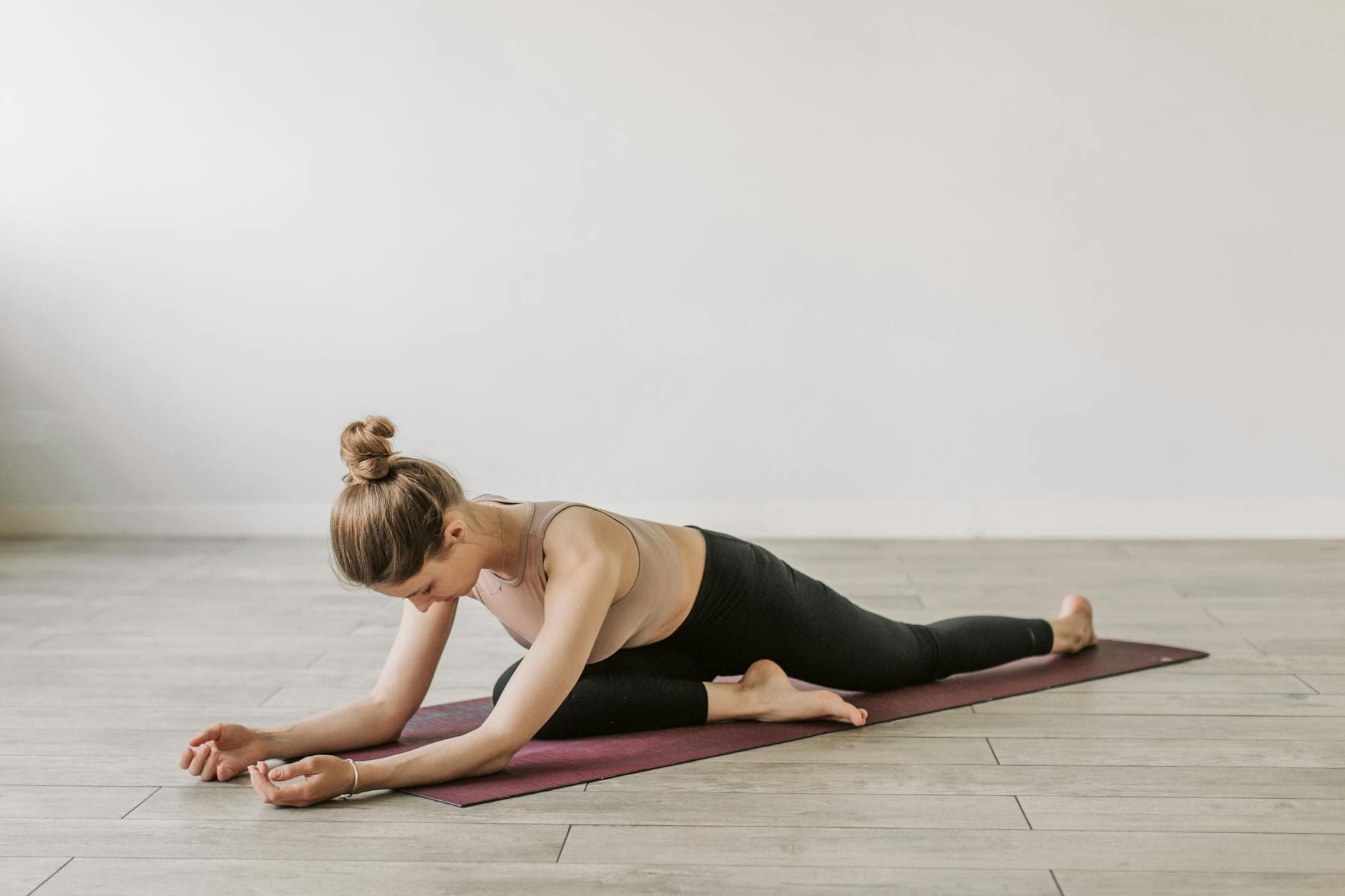 Woman in yoga pose on mat, promoting fitness and wellness indoors. - pilates mat exercises