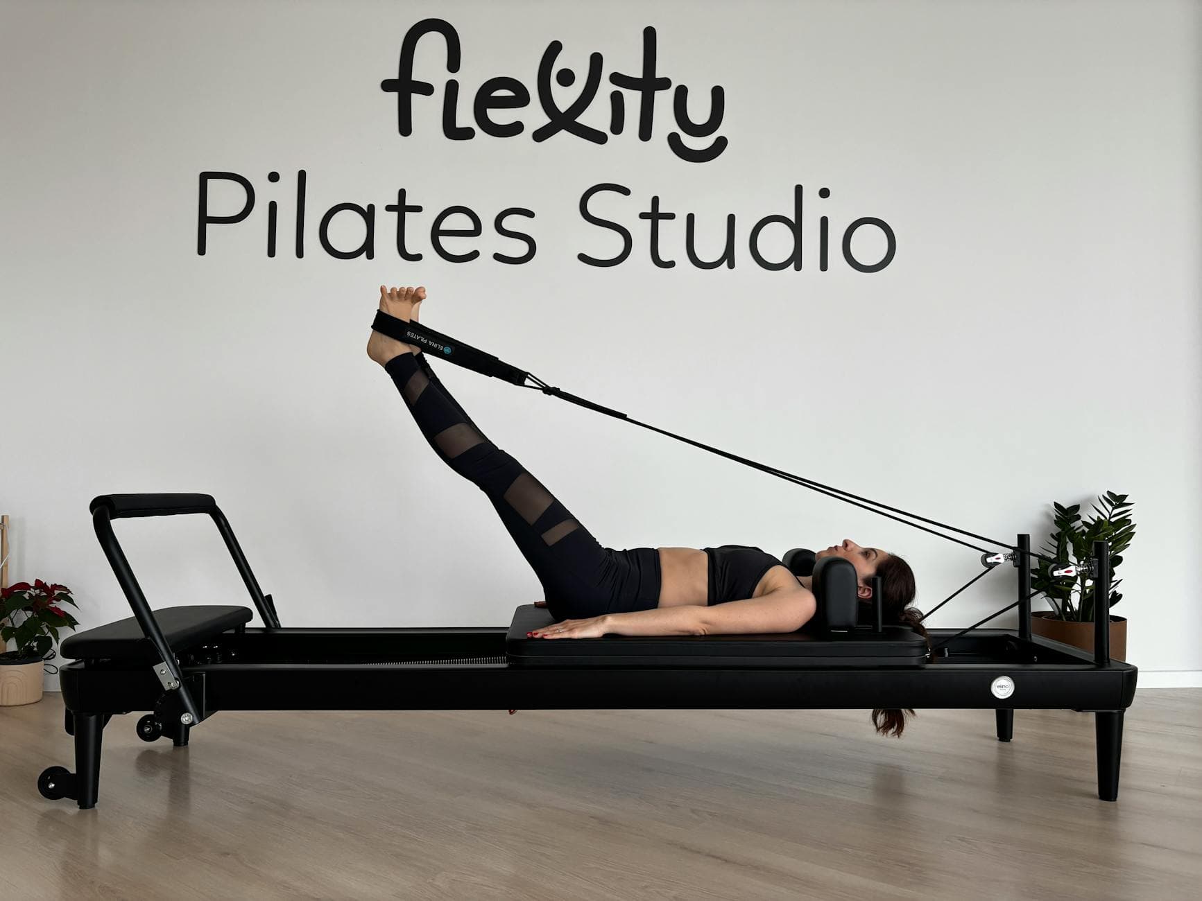 Woman performing pilates exercises on a reformer at Flexity Pilates Studio. - pilates reformer exercises