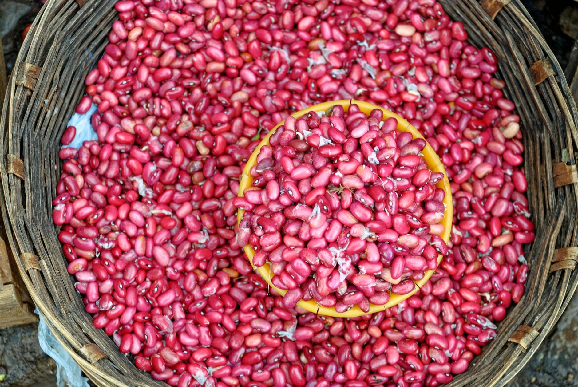 Vibrant pink beans filling a woven basket, showcasing freshness and abundance. - vegan protein sources