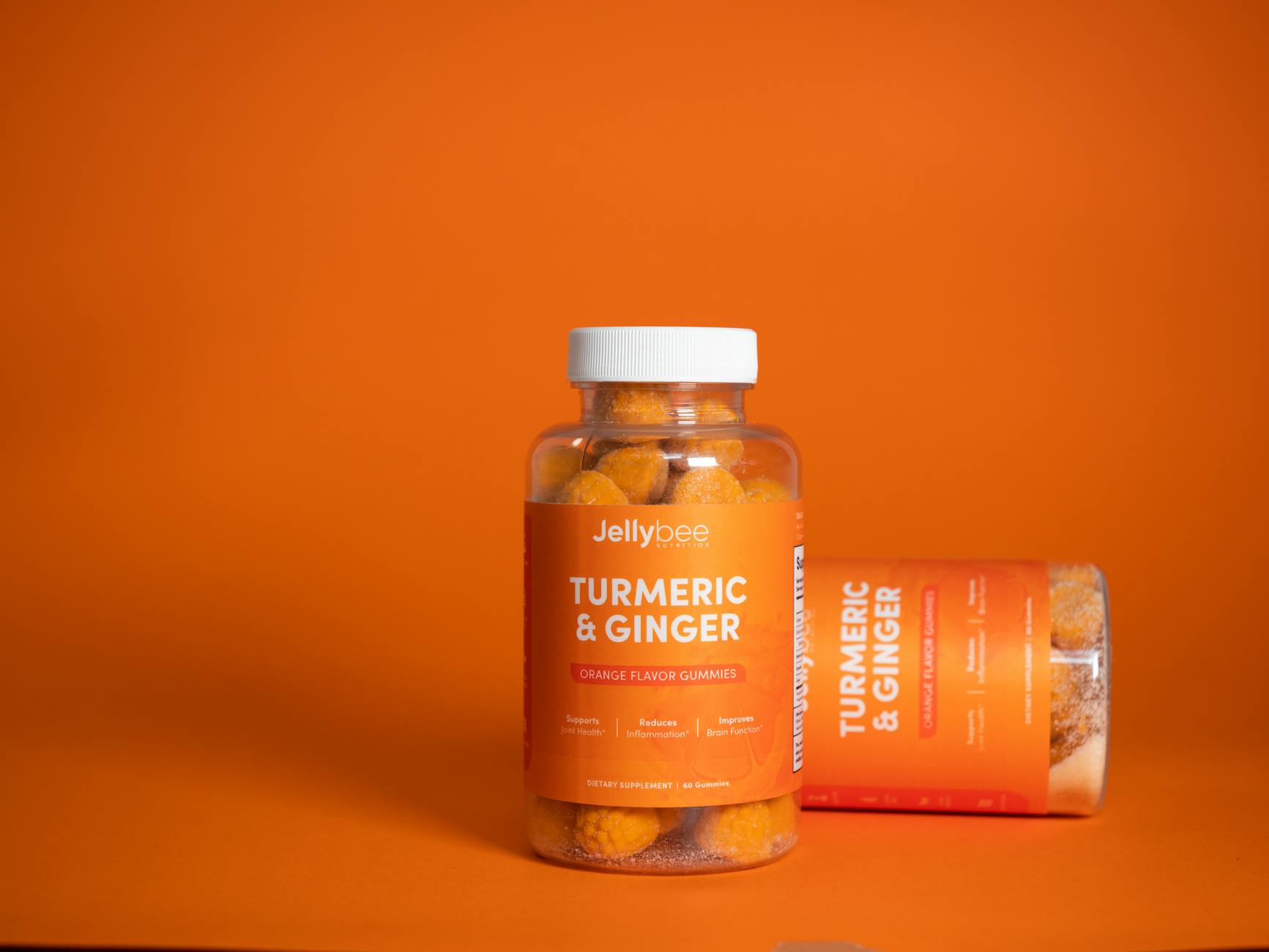 Vibrant product shot of Jellybee turmeric and ginger gummies in an orange setting. - anti inflammatory diet