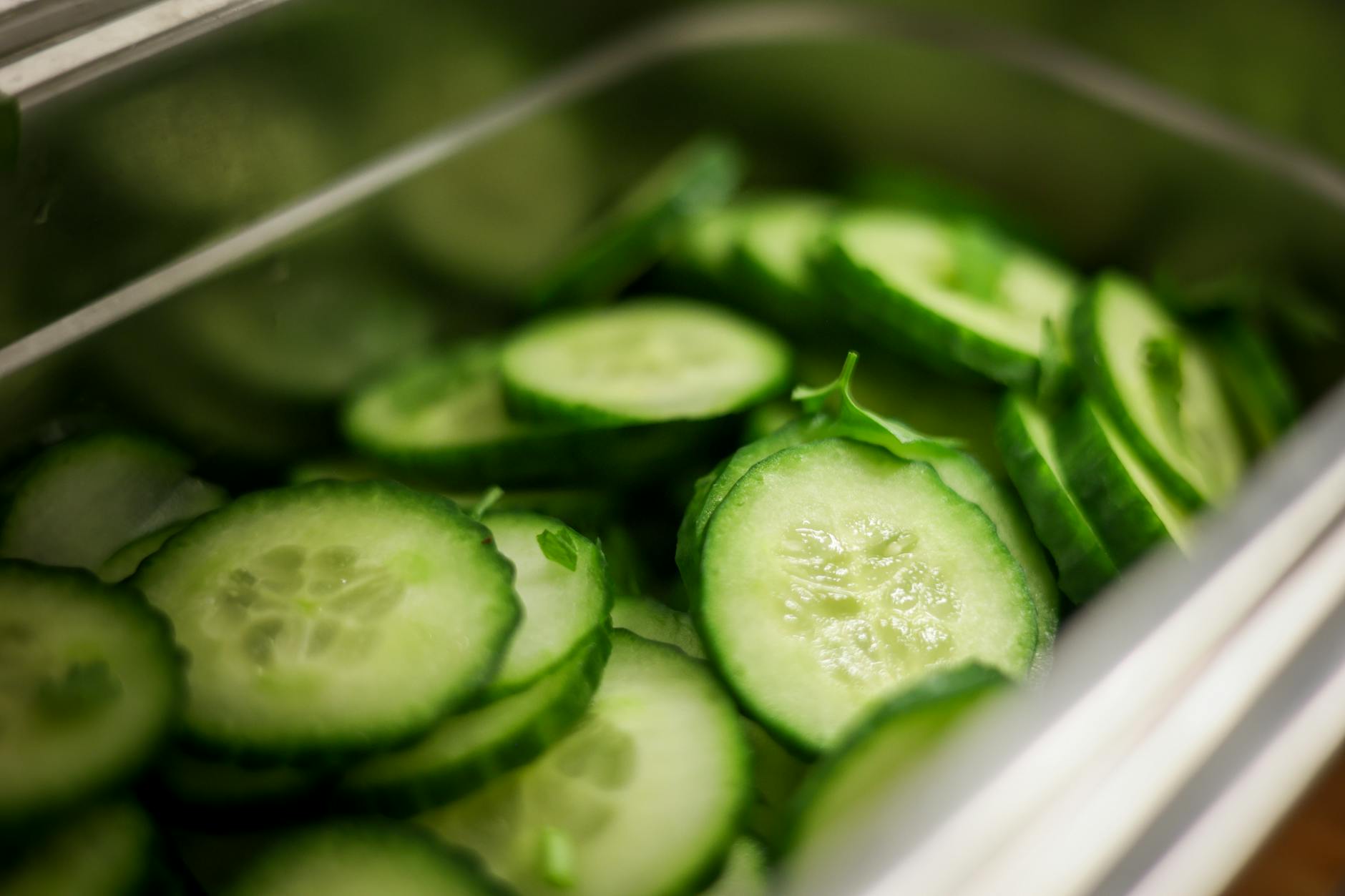 Close-up of fresh cucumber slices in a steel container, showcasing healthy and nutritious vegetables. - anti inflammatory diet