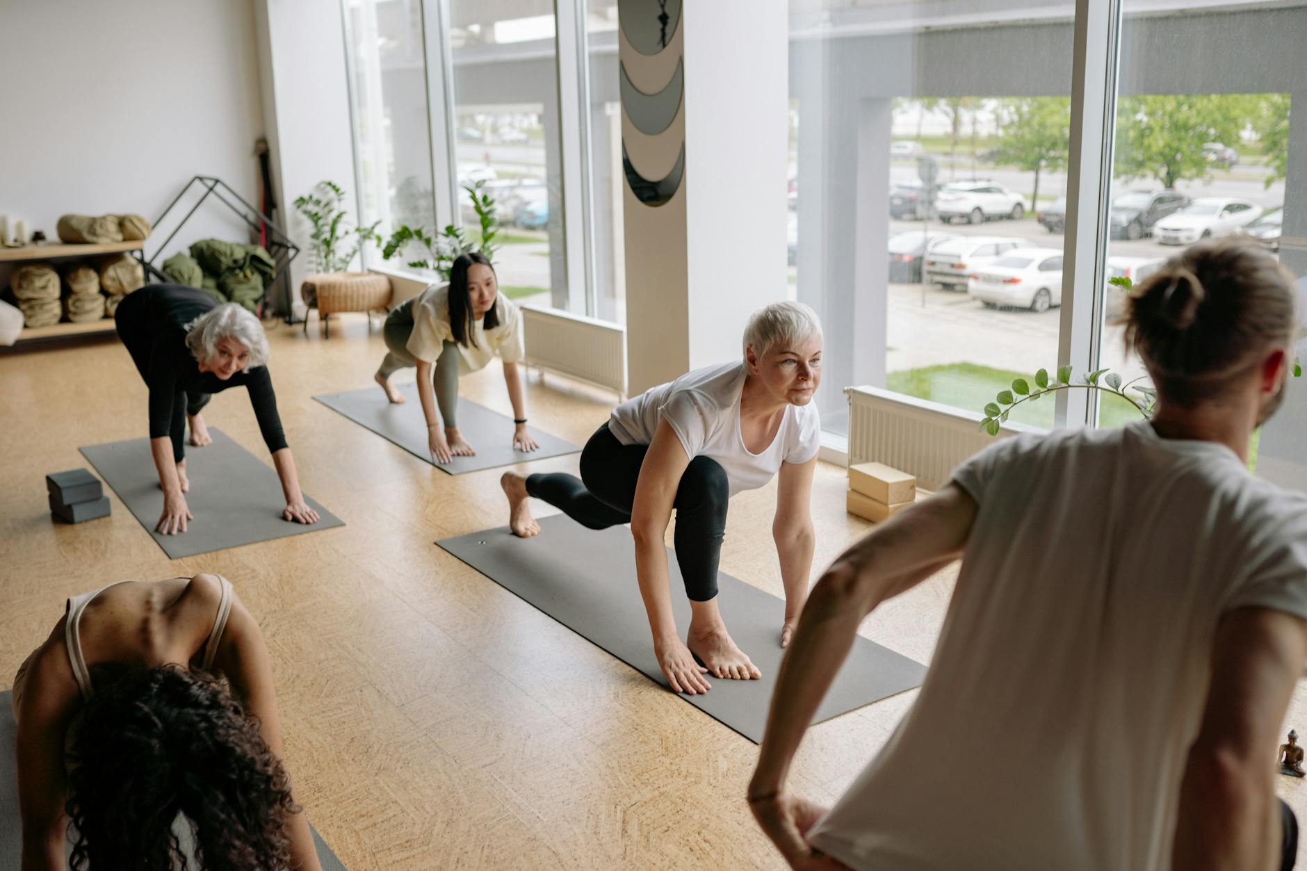 Adults practicing yoga indoors, focusing on mindfulness and flexibility exercises. - beginner yoga poses