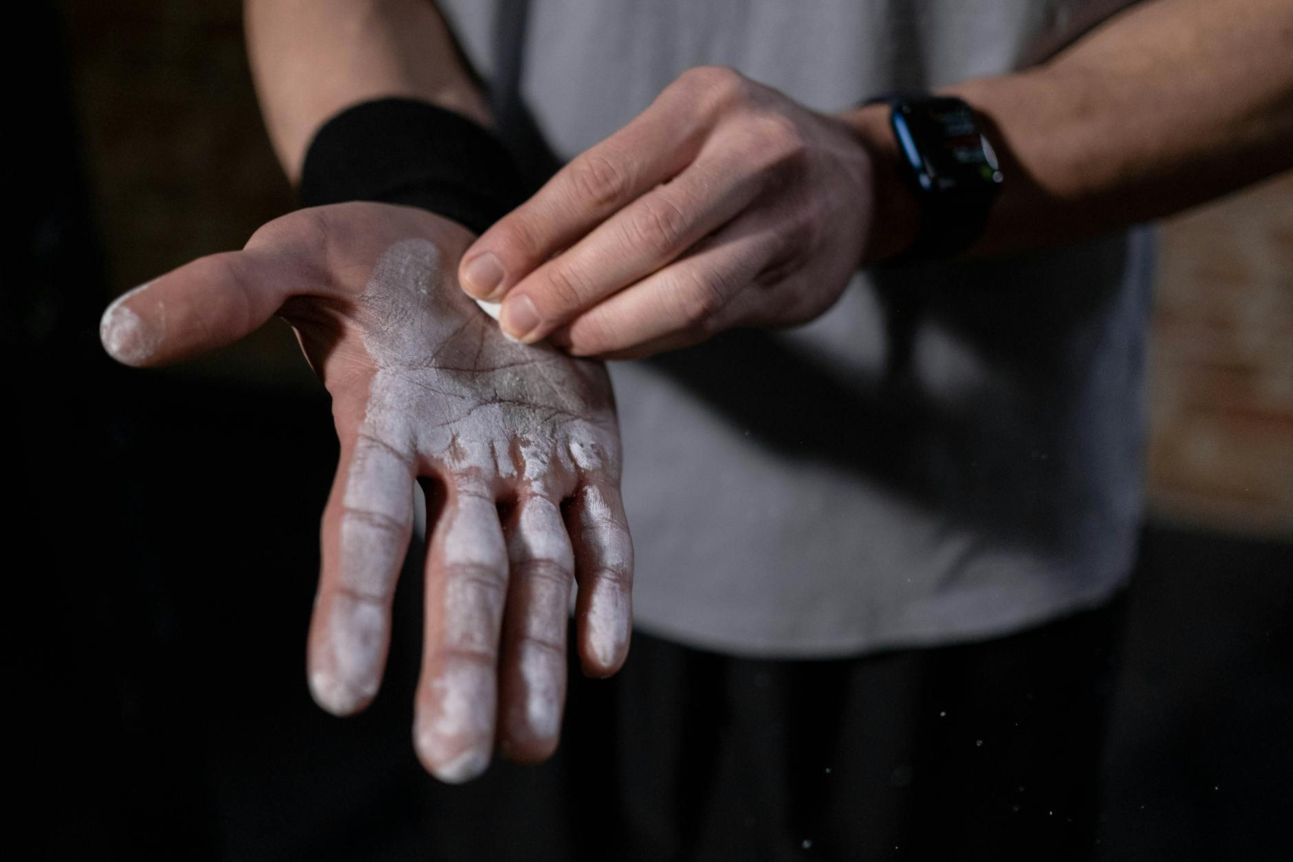 A detailed view of a hand applying gym chalk indoors, symbolizing fitness and preparation. - c4 pre workout ingredients
