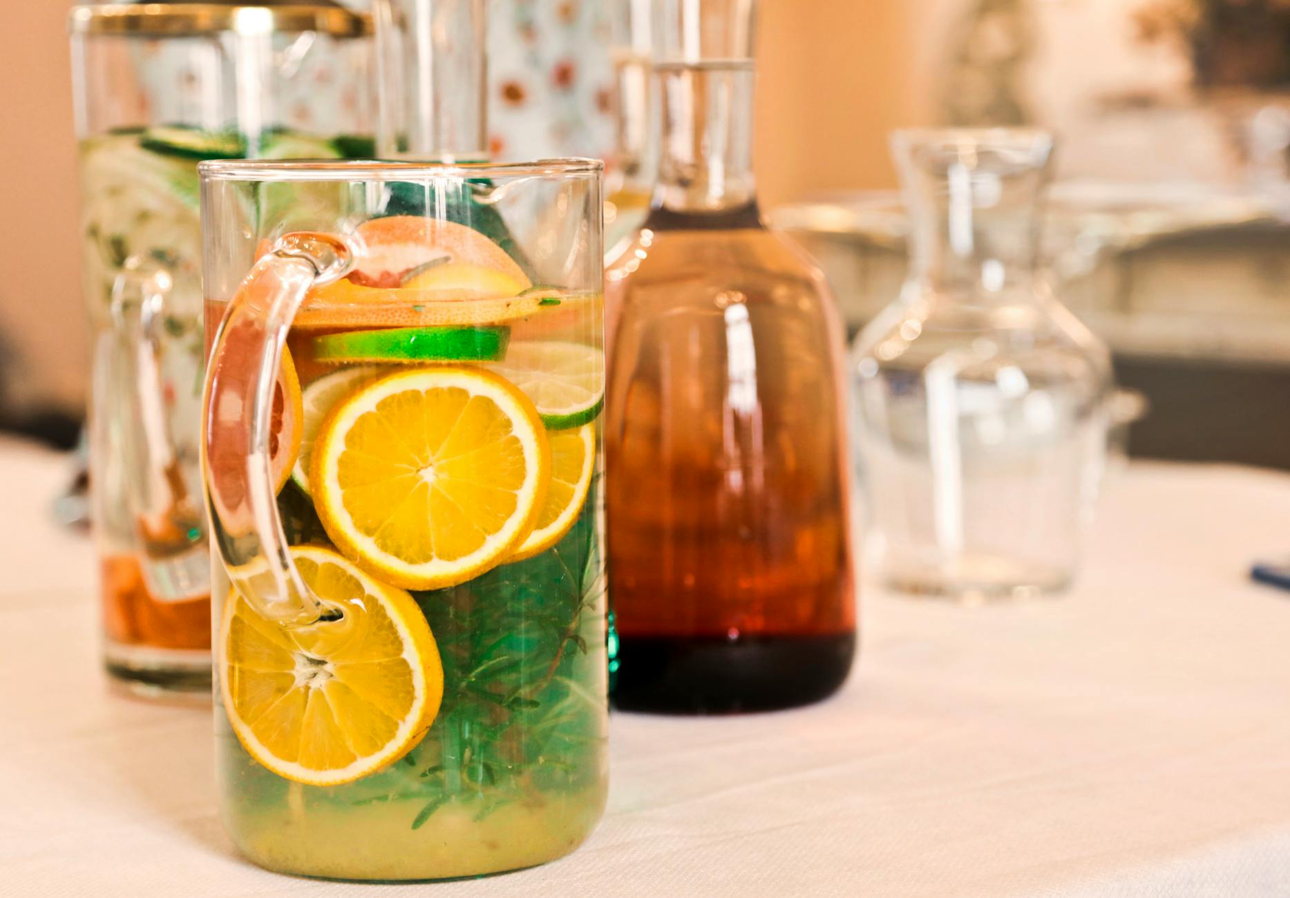 Colorful pitchers of citrus-infused water offer a refreshing beverage choice. - cucumber lemon detox water