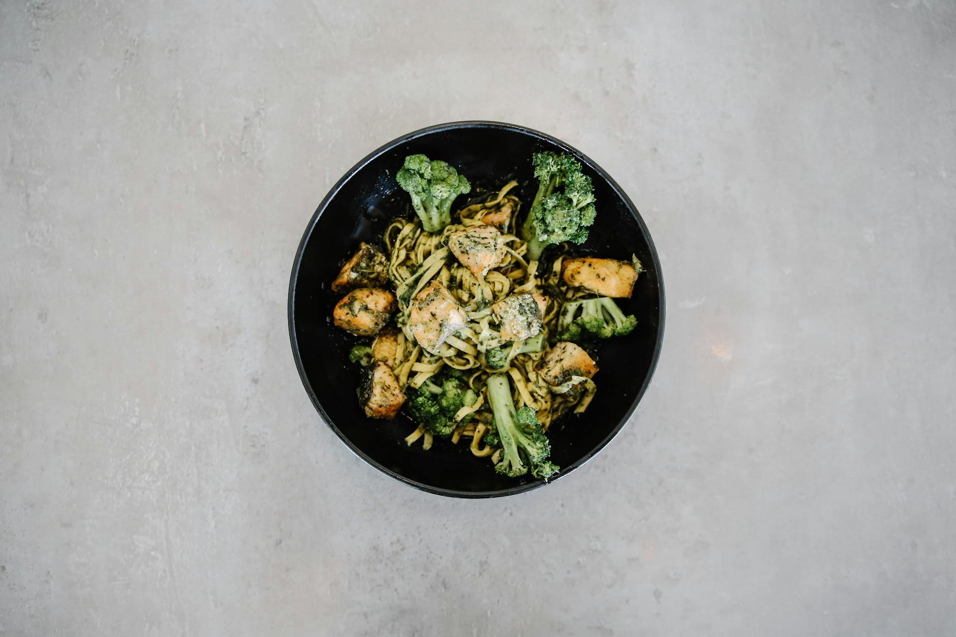 Top view of a tasty broccoli and chicken pasta in a black bowl, perfect for healthy dining visuals. - free keto recipes