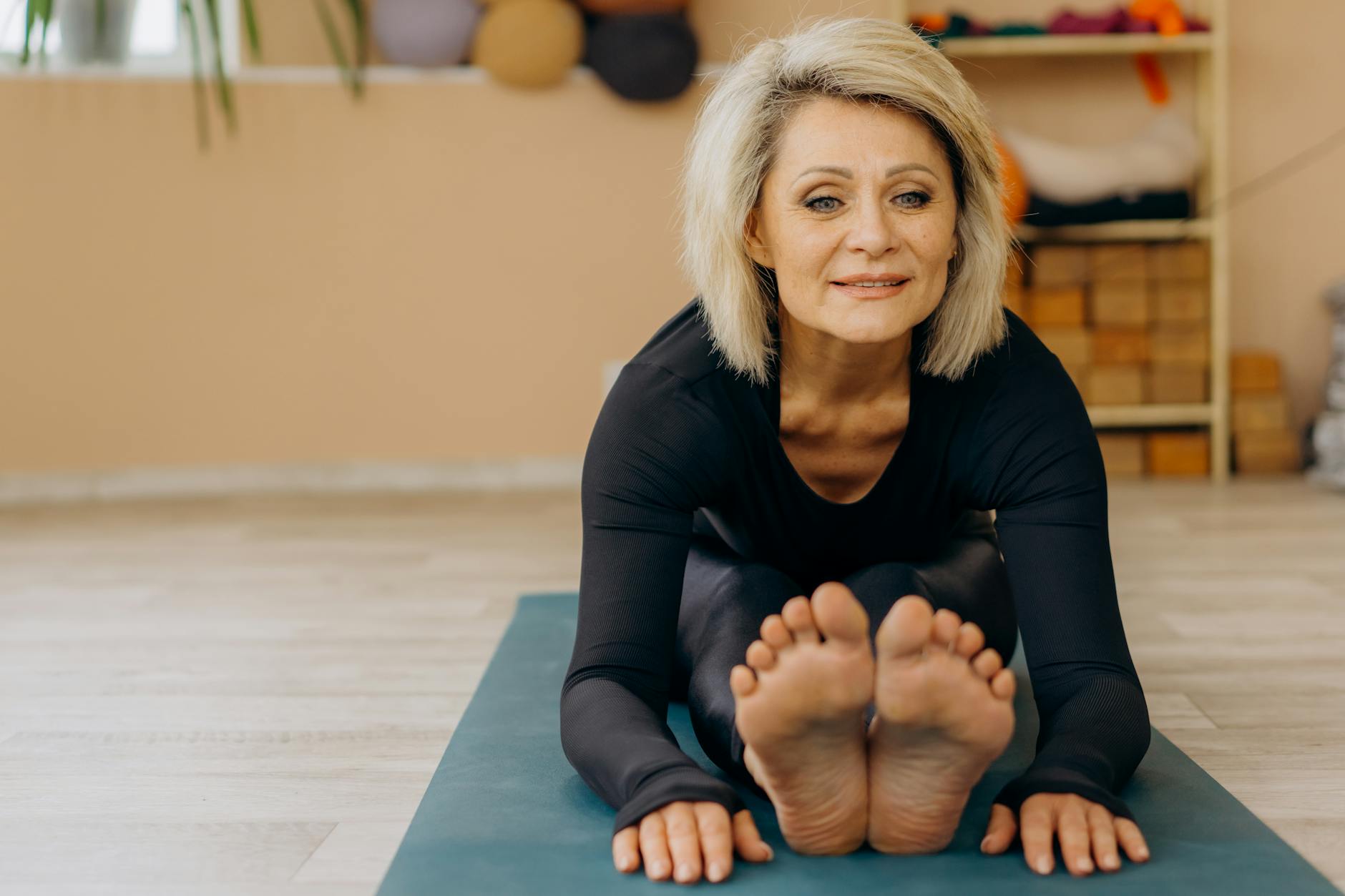 Elderly woman doing yoga indoors, promoting wellness and positive aging. - healthy aging tips seniors
