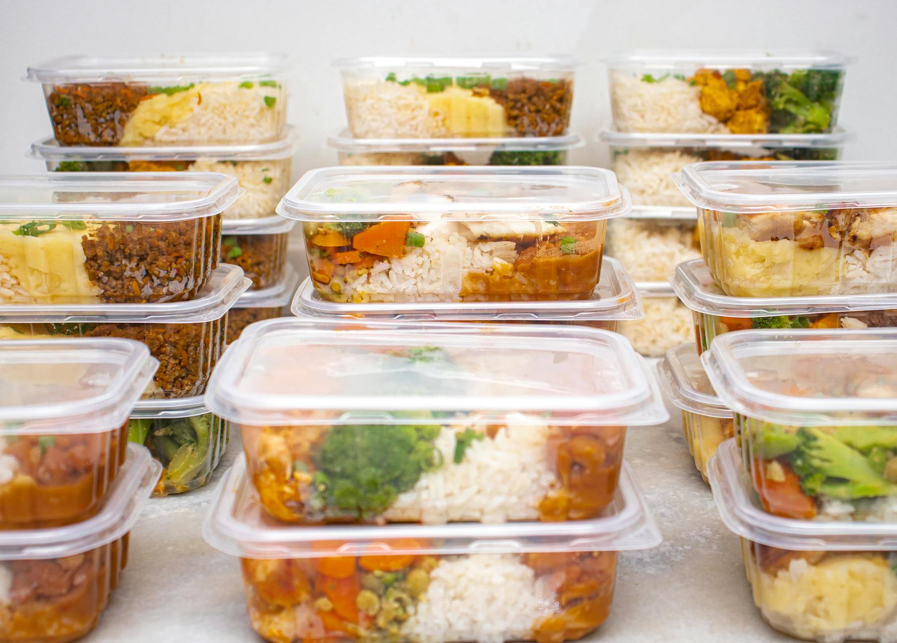 Multiple containers of prepared meals with rice and vegetables for easy meal management. - healthy meal plan ideas