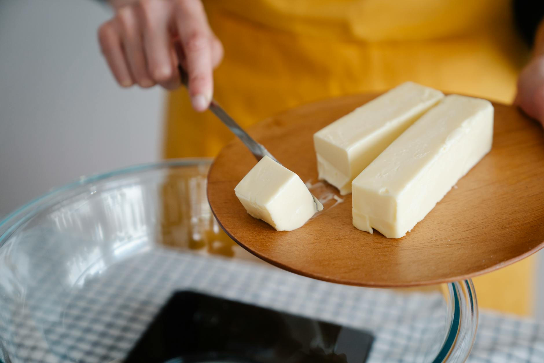 Focused shot of cutting butter for meal preparation, essential cooking ingredient. - keto recipes for beginners