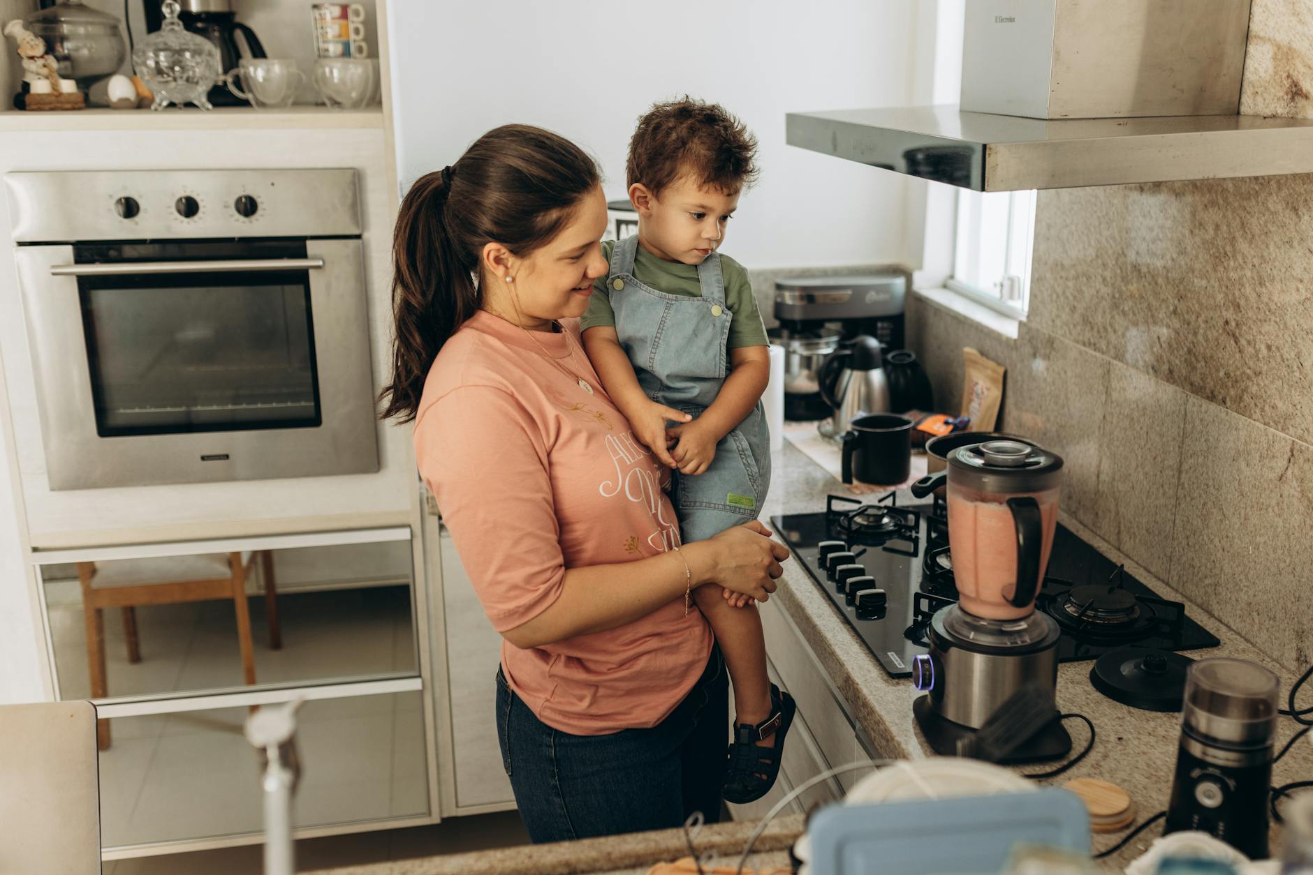 Mother and son enjoying smoothie preparation in a cozy kitchen setting. - kid-friendly smoothie recipes
