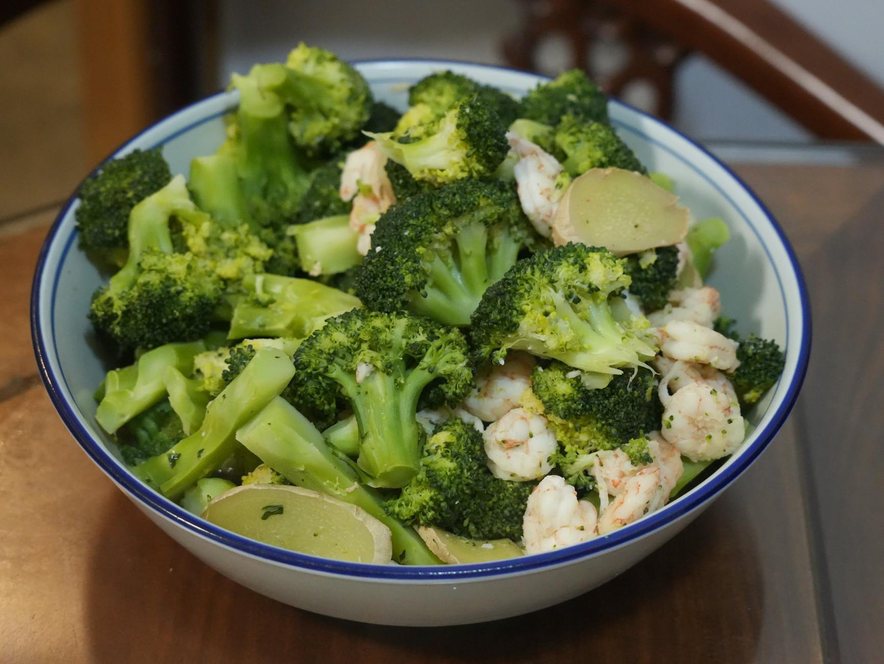 A delicious bowl filled with fresh broccoli, shrimp, and ginger slices, perfect for a healthy meal. - low carb dinner recipes