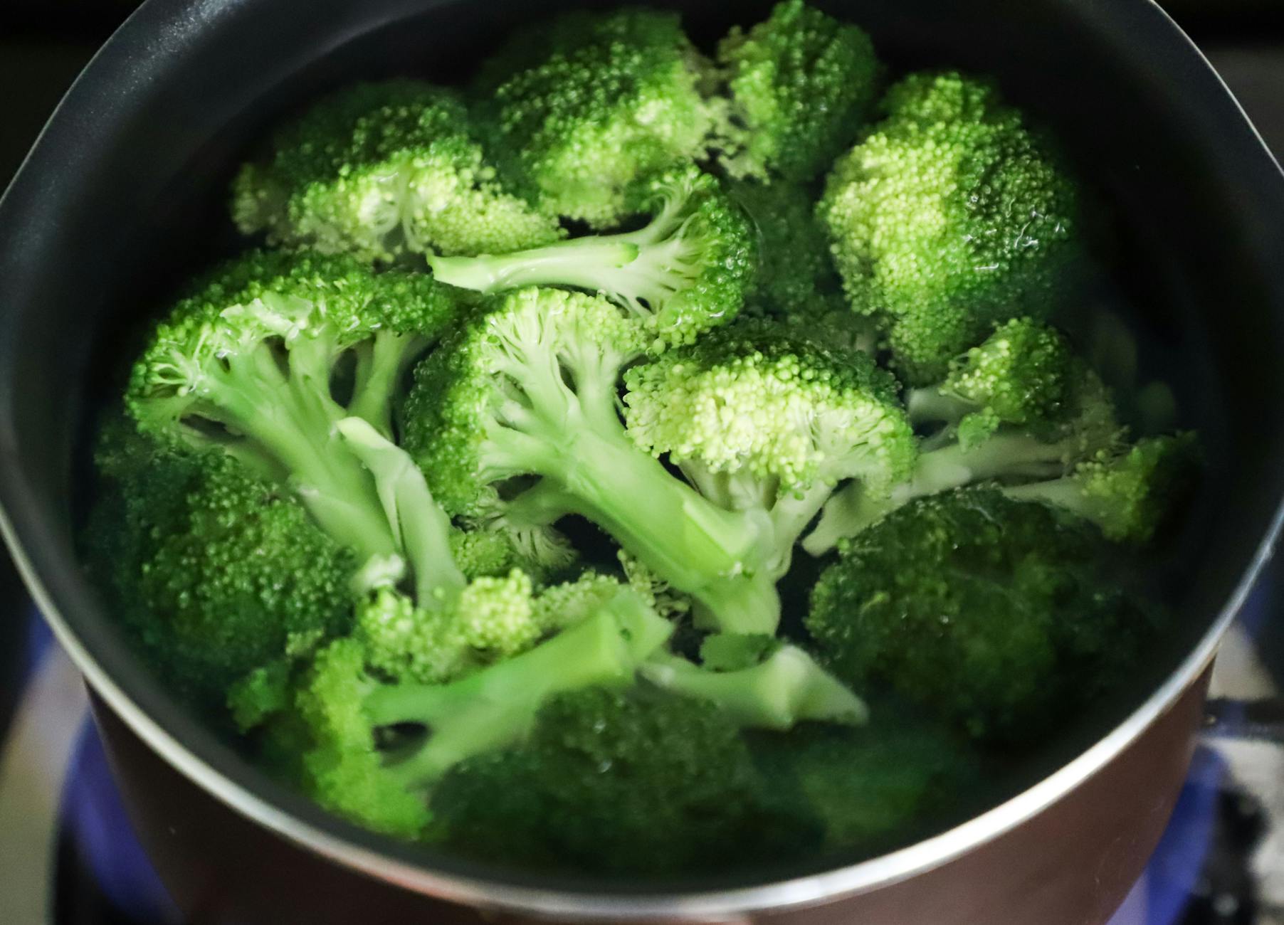 Bright green broccoli florets boiling in a pot for a fresh, healthy meal. - best keto diet recipes