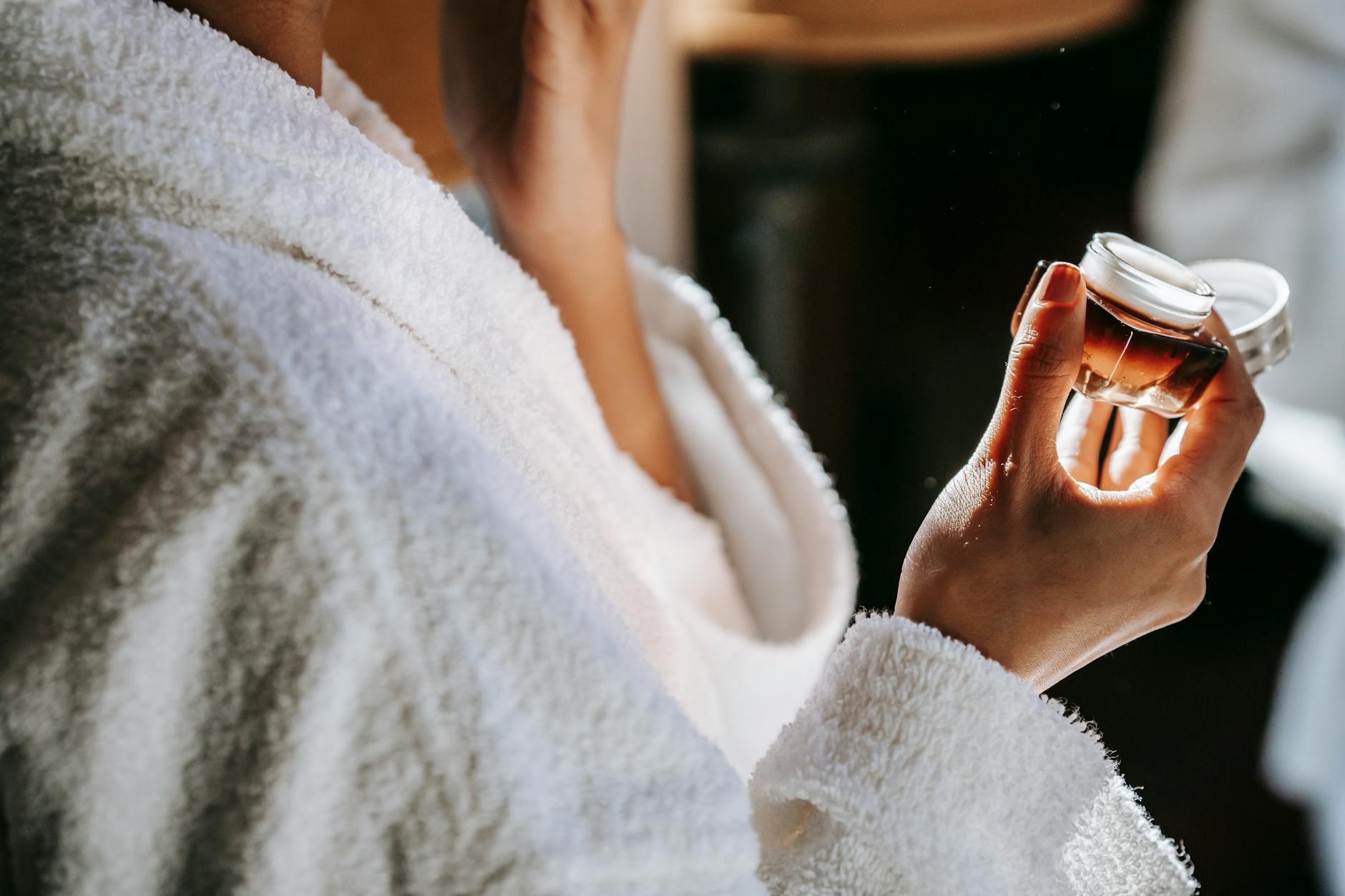 Close-up of woman applying natural cream during daily skincare routine, emphasizing self-care and wellness. - best natural moisturizer