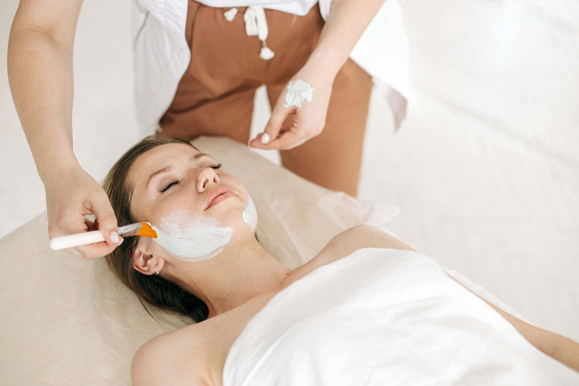 Woman receiving a rejuvenating facial treatment at a spa, promoting skin care and relaxation. - best natural skin care