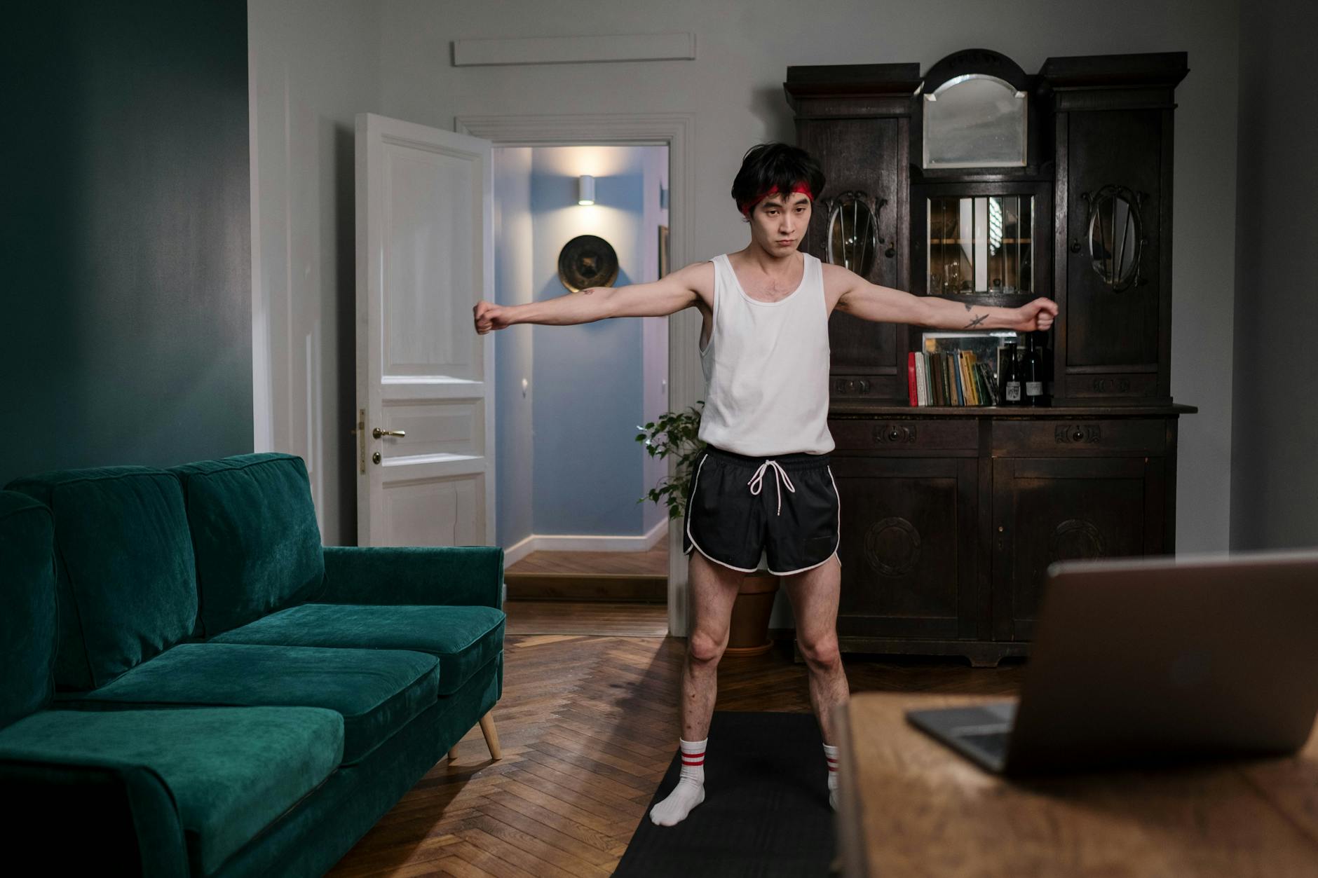 Asian man exercising indoors at home, focusing on health and fitness. - bodyweight workouts home