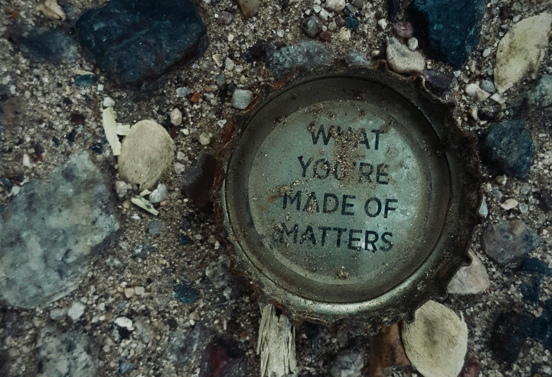 Photograph of a rusty bottle cap on gravel with the message 'What You're Made Of Matters.' - what is core