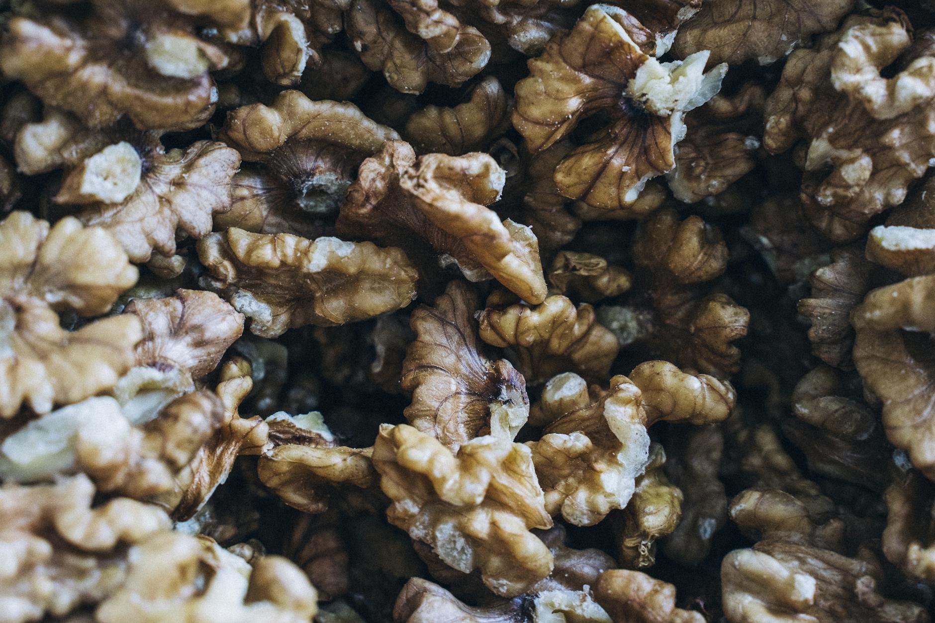 Detailed close-up of shelled walnuts showcasing their rich texture and natural colors. - fat burning foods