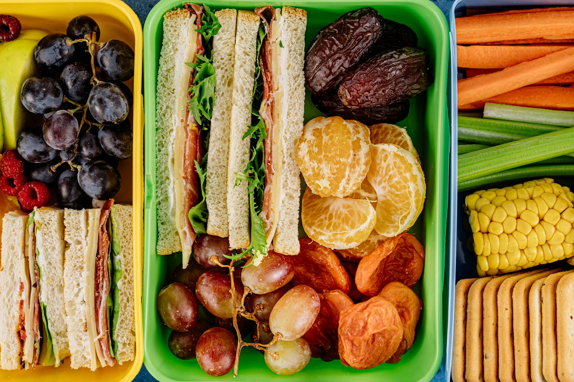 Colorful lunchbox filled with sandwiches, fresh fruits, and vegetables, perfect for a healthy meal. - healthy kids lunches