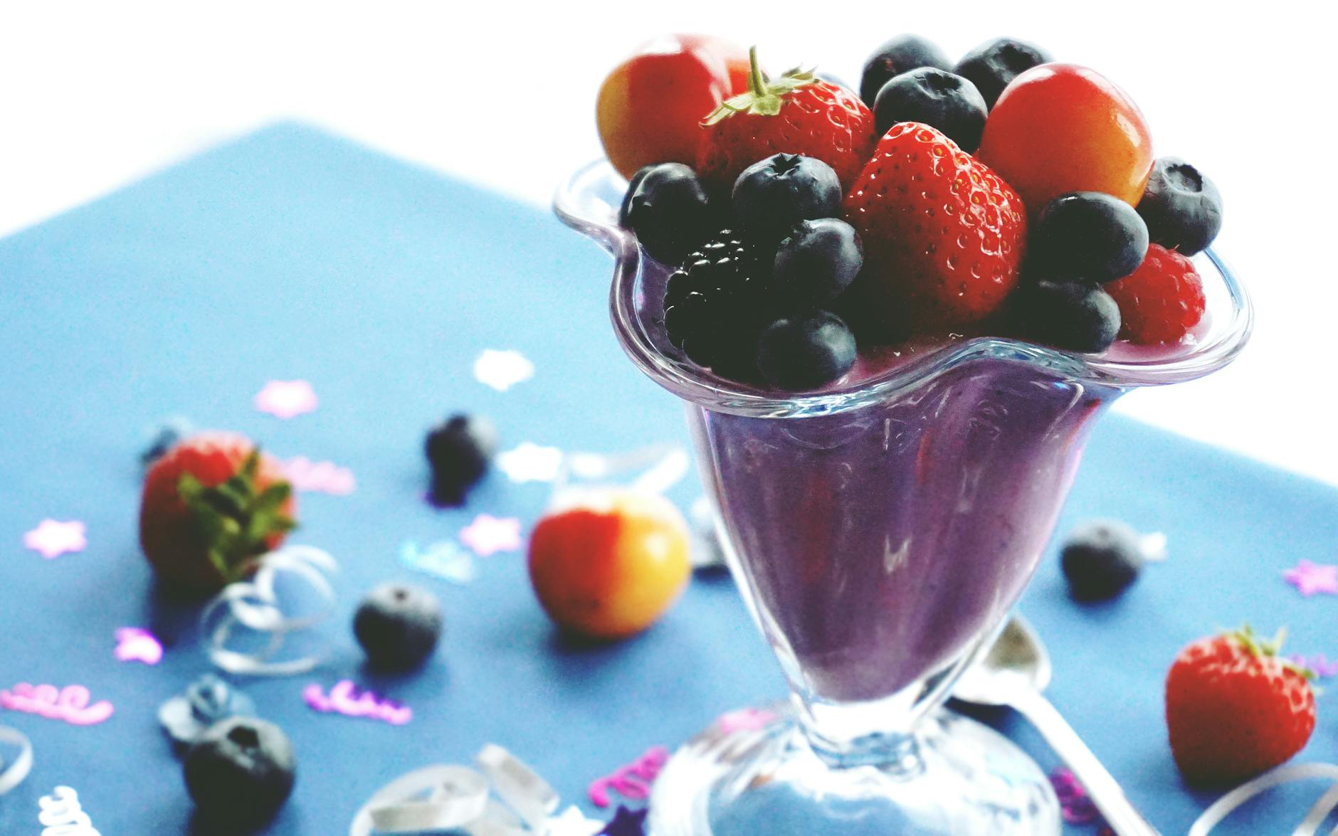 Delicious and healthy mixed berry smoothie topped with fresh fruits. Perfect summer refreshment. - healthy smoothies