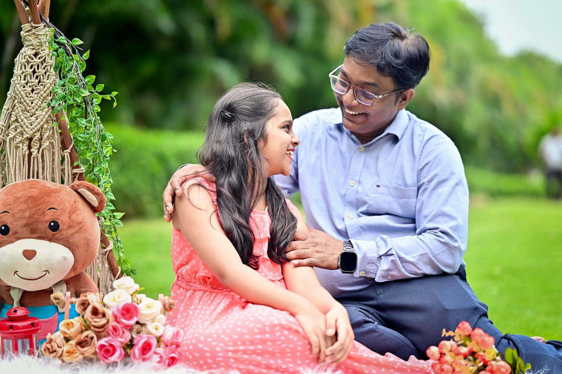 Happy father and daughter bonding during a cheerful outdoor picnic in a garden. - healthy snacks near me
