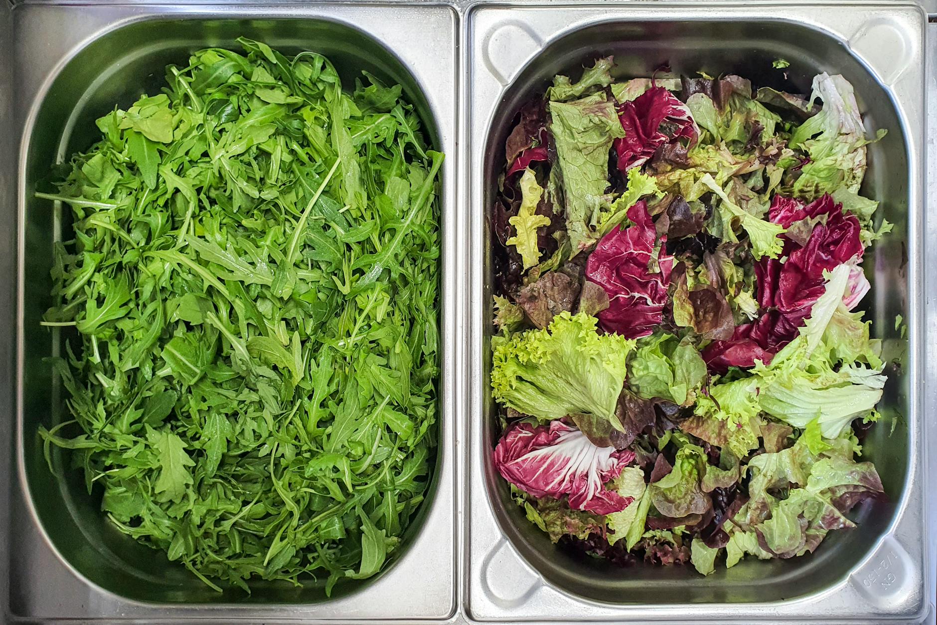 Two trays filled with fresh arugula and mixed lettuce, top view. - magnesium citrate benefits