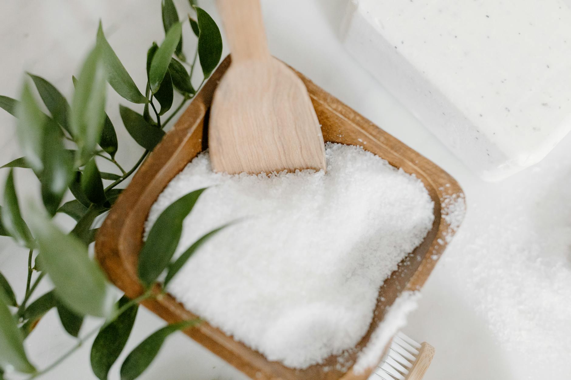 Close-up of bath salts, wooden spoon, and natural elements for a spa setting. - magnesium oxide benefits