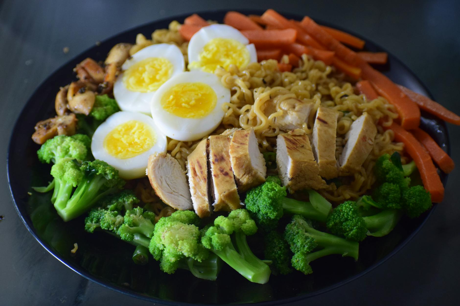 Delicious noodle dish with chicken, broccoli, eggs, and carrots, perfect for a healthy meal. - meal prep ideas