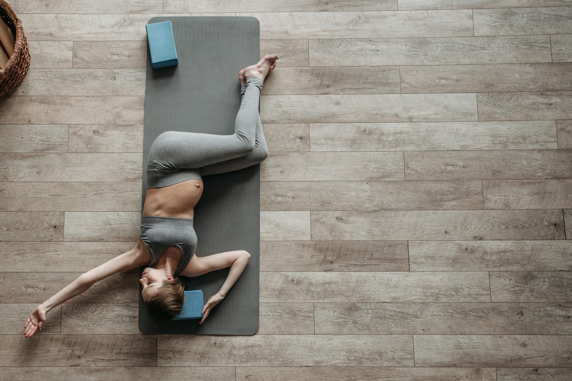 Pregnant woman performing yoga exercise indoors on a mat for health and relaxation. - mindful meditation benefits