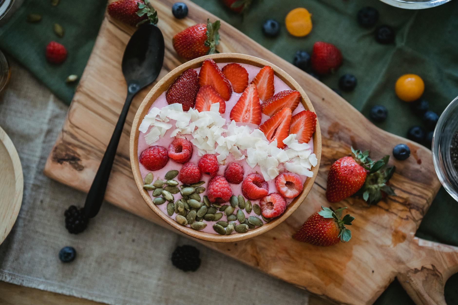 Bright and colorful smoothie bowl topped with fresh berries, seeds, and coconut flakes for a nutritious start. - probiotic foods boost