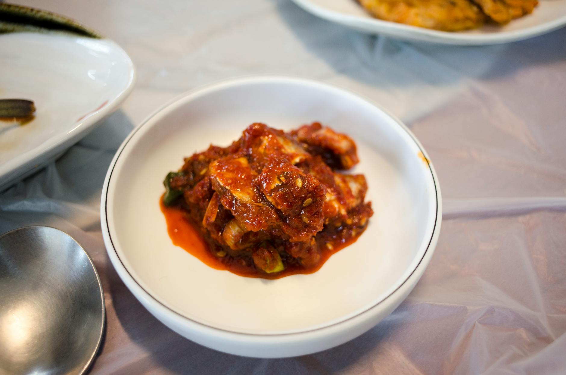 A vibrant bowl of traditional Korean kimchi, capturing the rich spices and colors. - probiotic rich foods