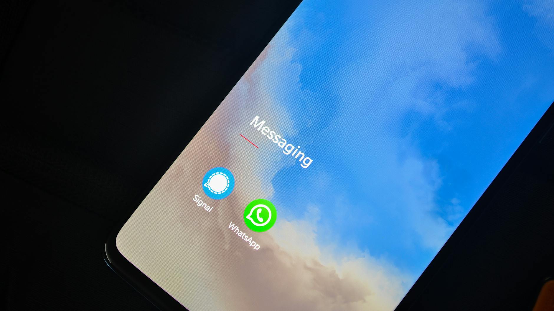 Close-up of smartphone screen showing Signal and WhatsApp messaging apps. - running apps for beginners