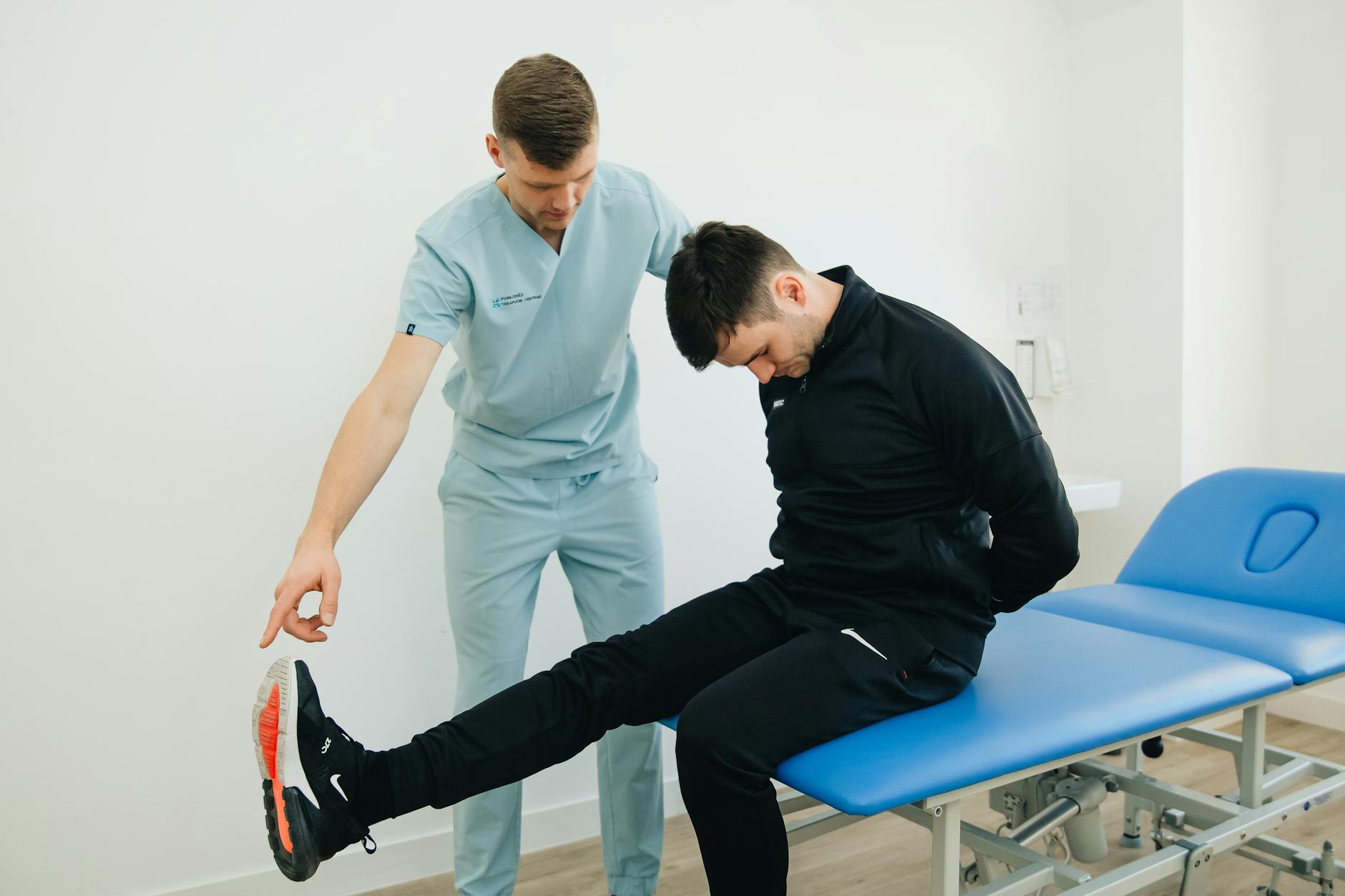 Physiotherapist instructing a patient on rehabilitation exercises in a clinic setting. - sciatica pain relief