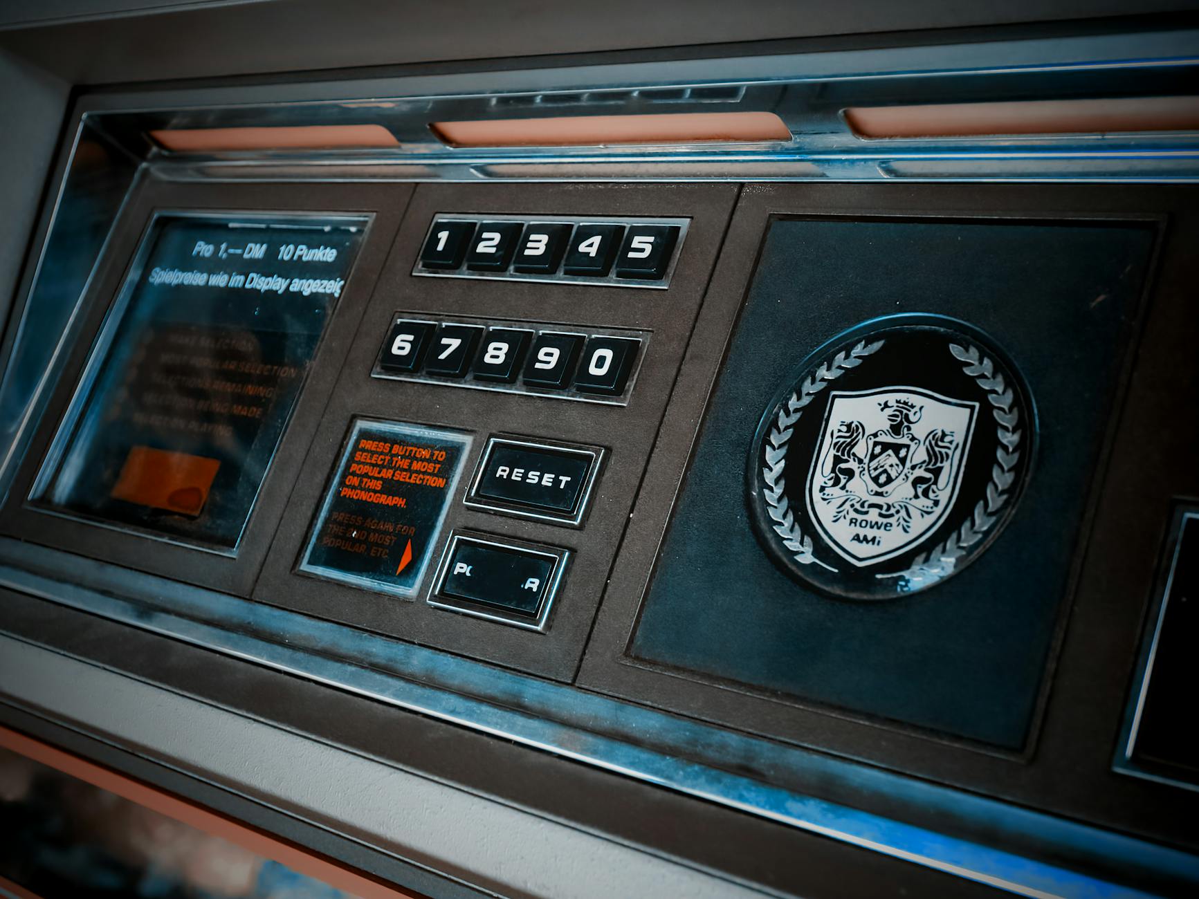 Close-up of a vintage arcade machine control panel with numeric keypad and emblem. - spring reset challenge