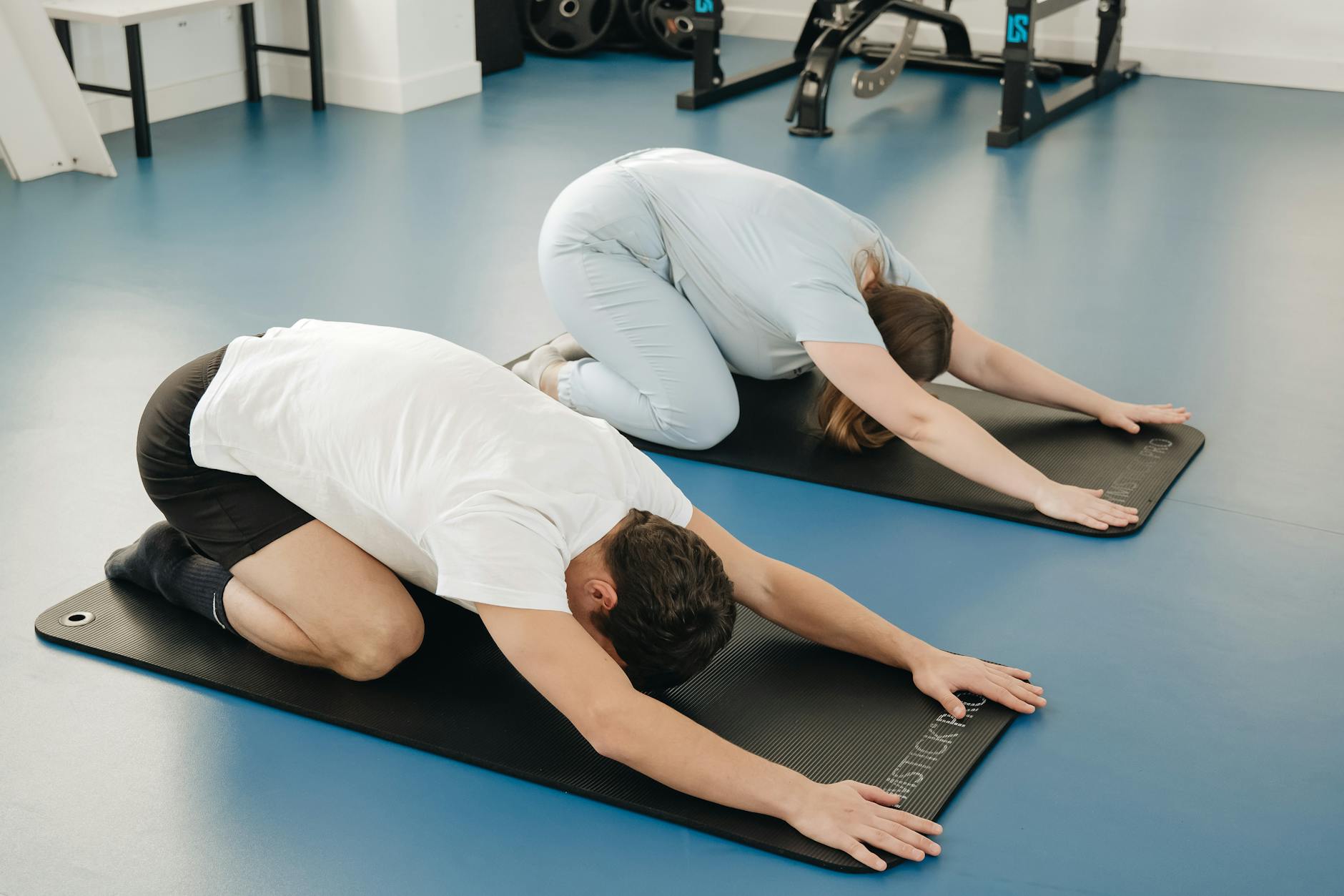 Adults practicing yoga poses in a Vilnius gym. Focus on health and flexibility. - stress relief exercises