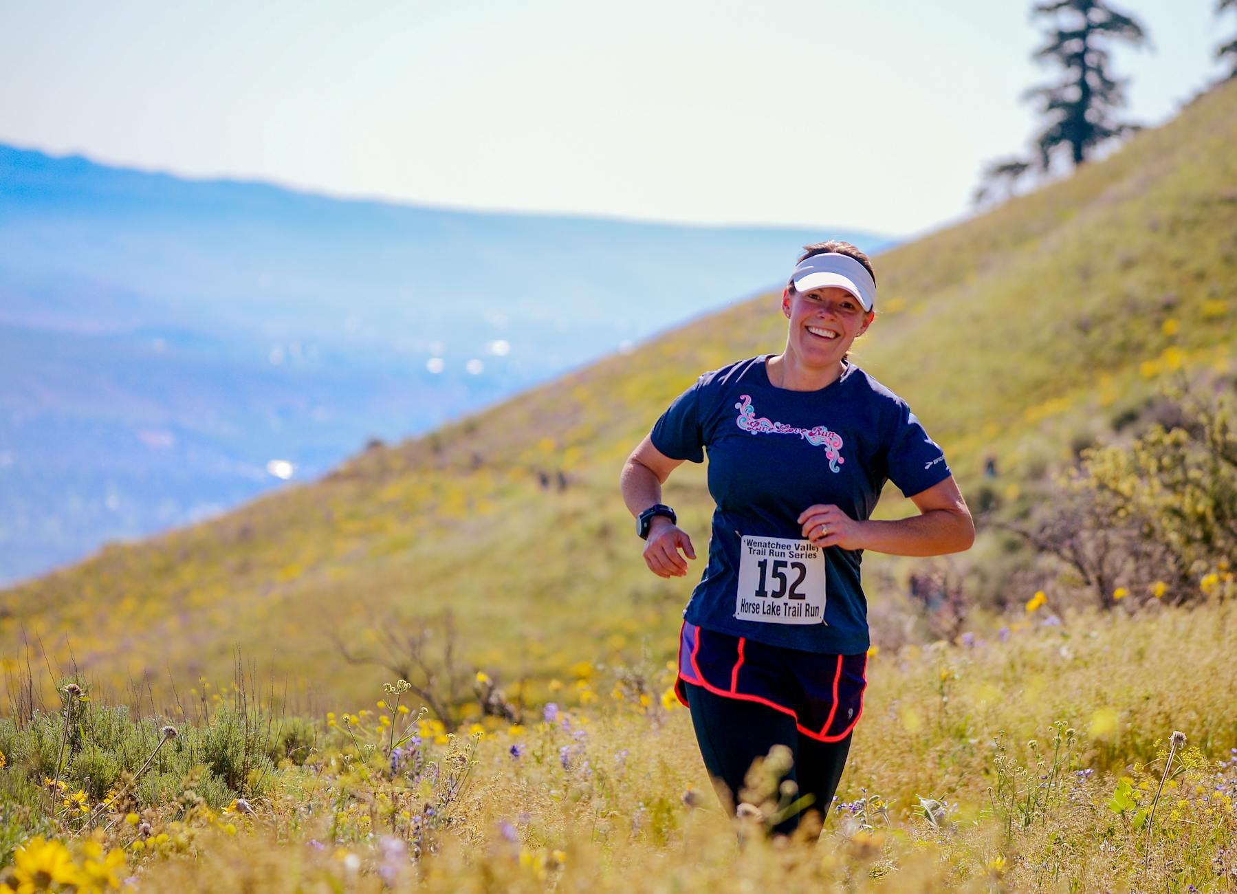 Woman enjoying a trail marathon in the vibrant hills of Wenatchee, Washington. - trail running beginners